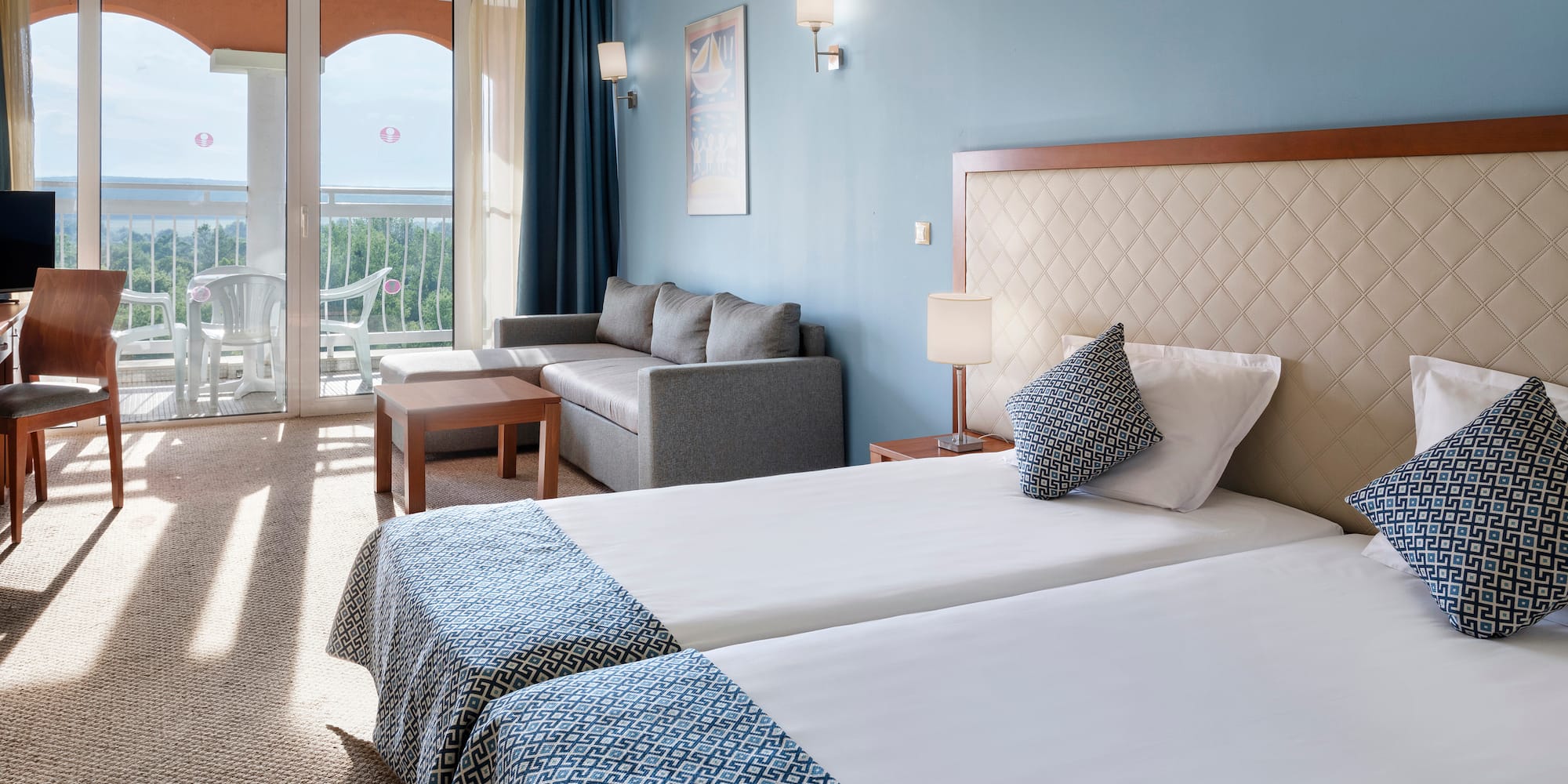 a room with two beds and a couch