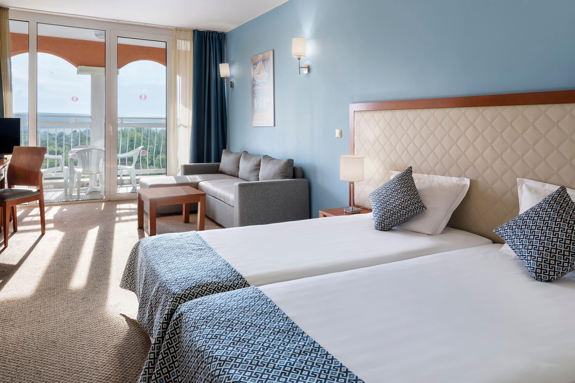 a room with two beds and a couch