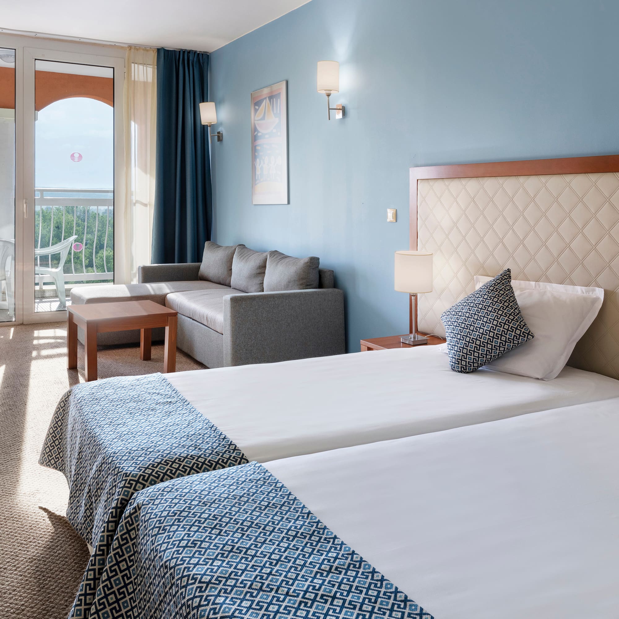 a room with two beds and a couch