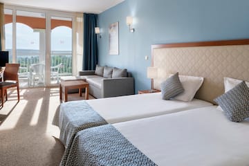 a room with two beds and a couch