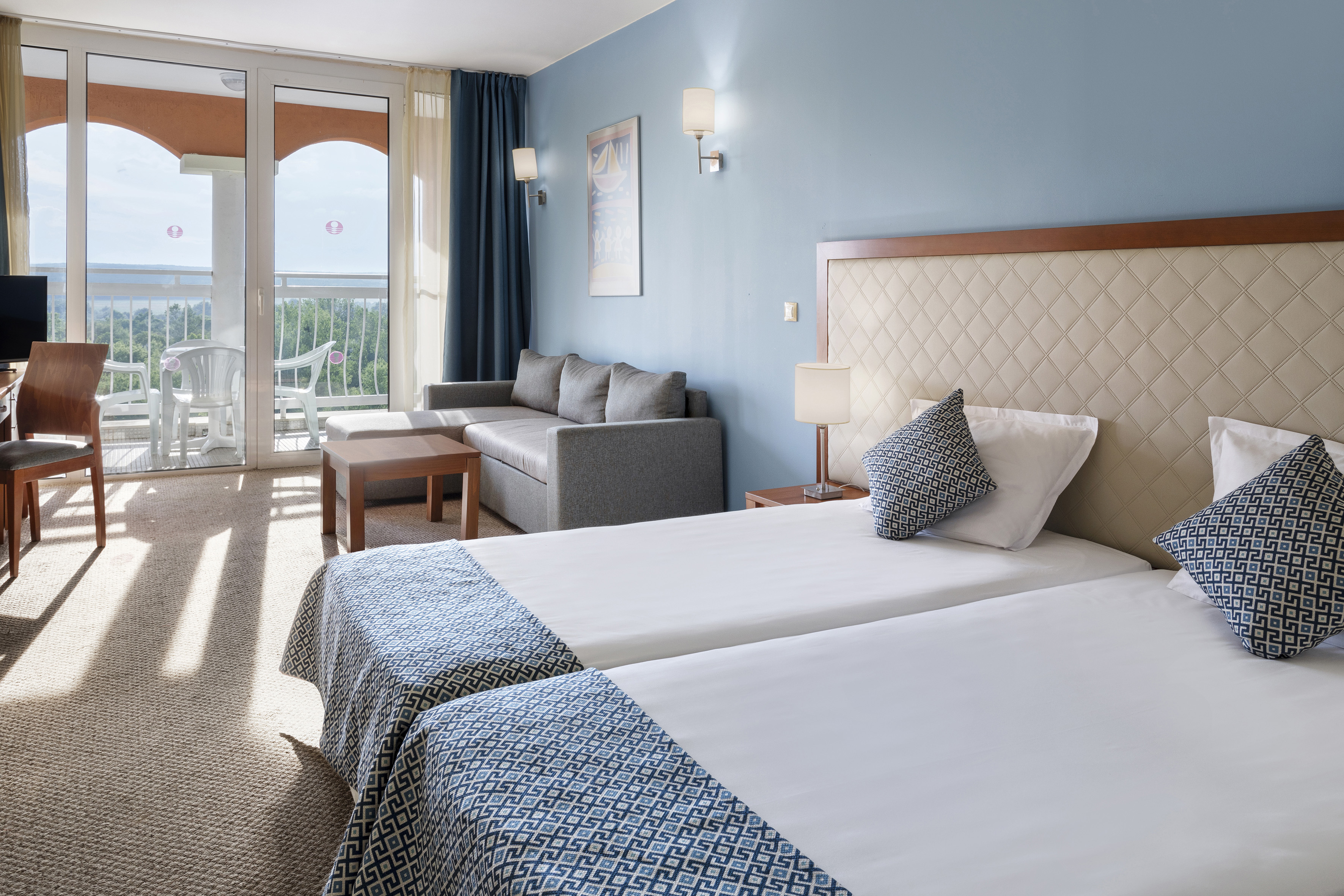 a room with two beds and a couch