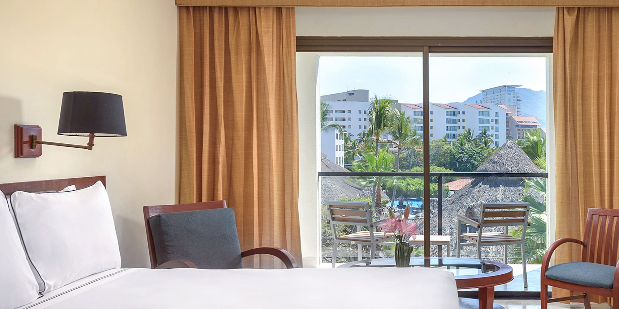 a room with a bed and chairs and a table