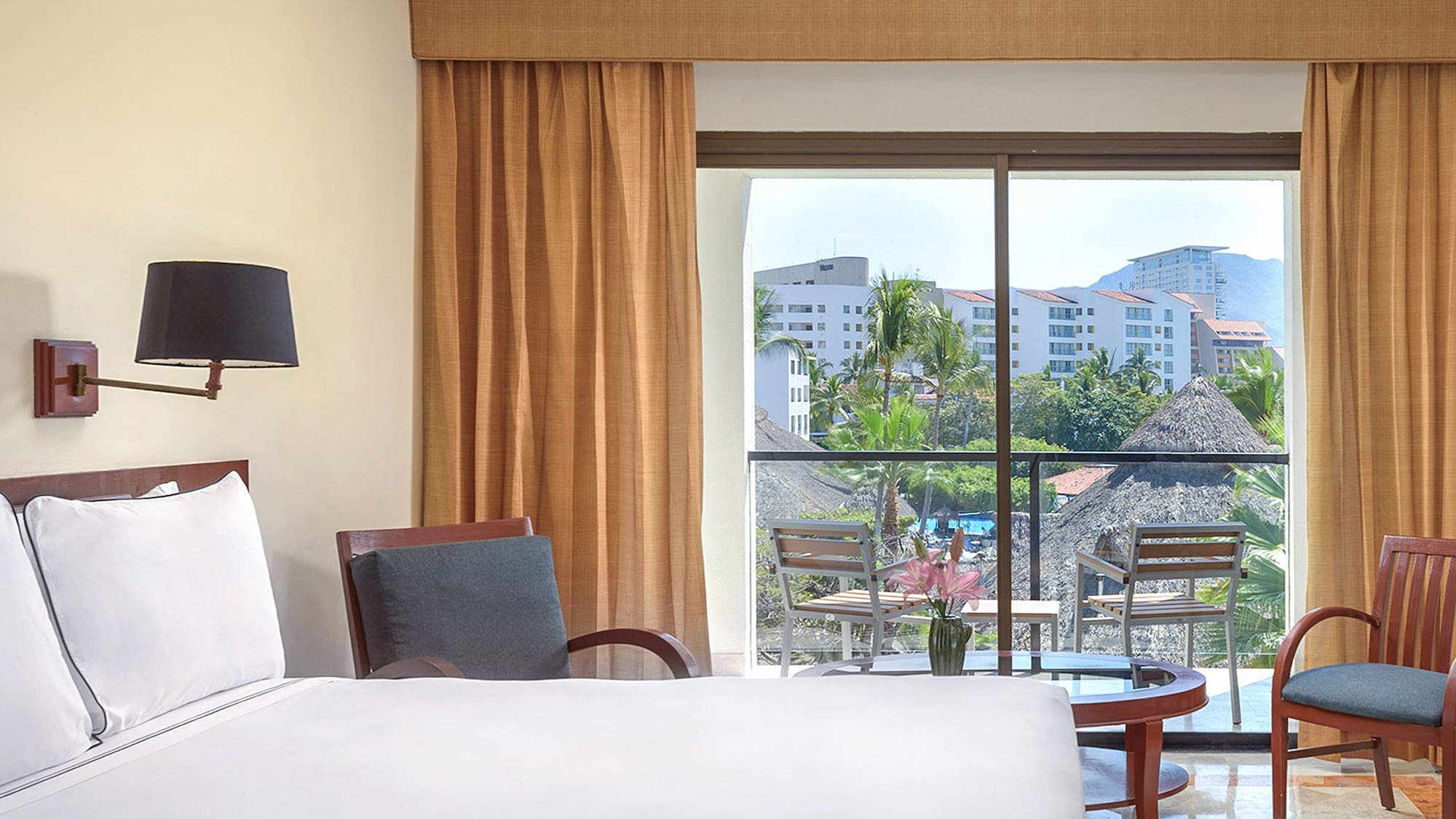 a room with a bed and chairs and a table