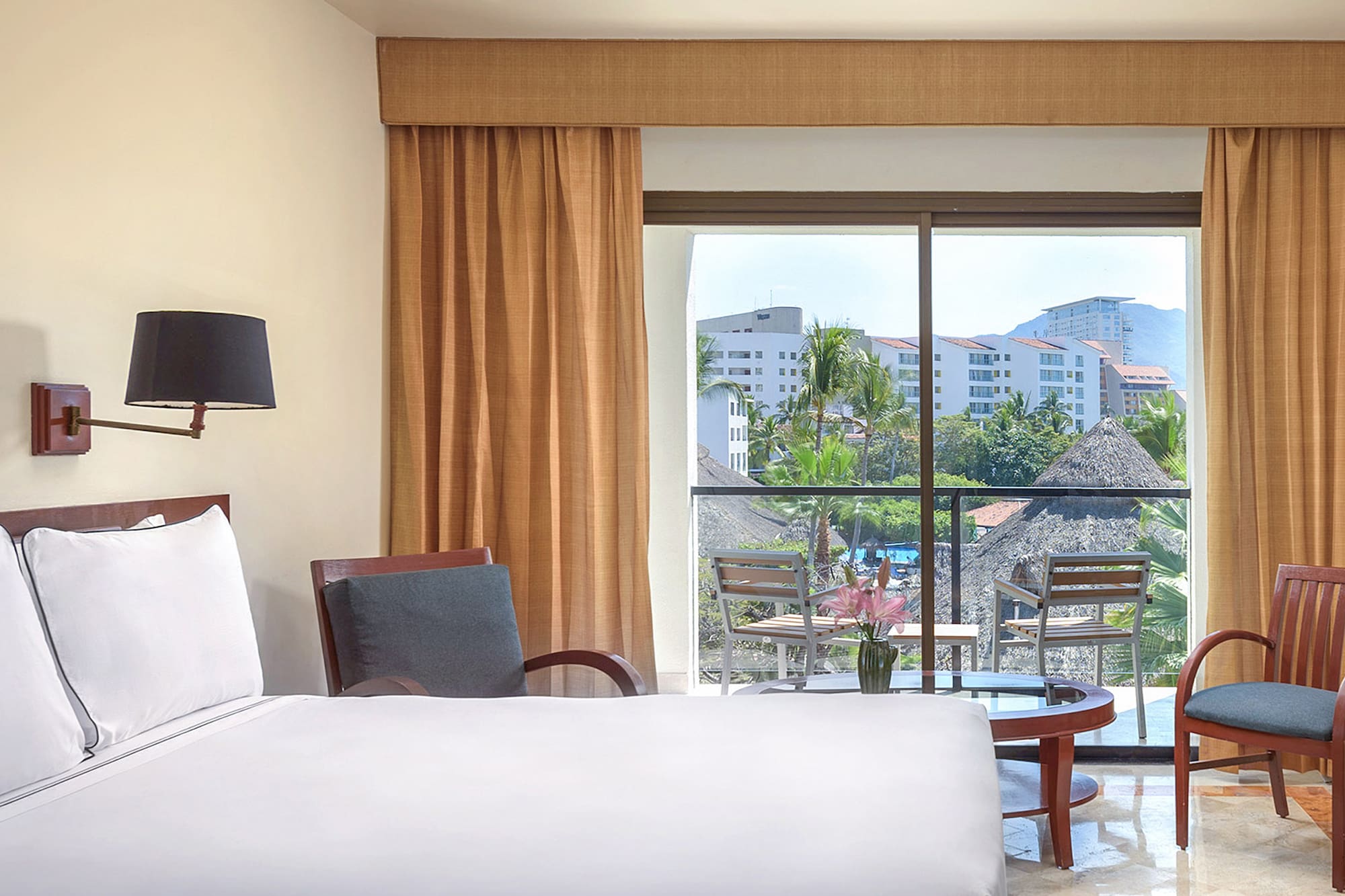 a room with a bed and chairs and a table