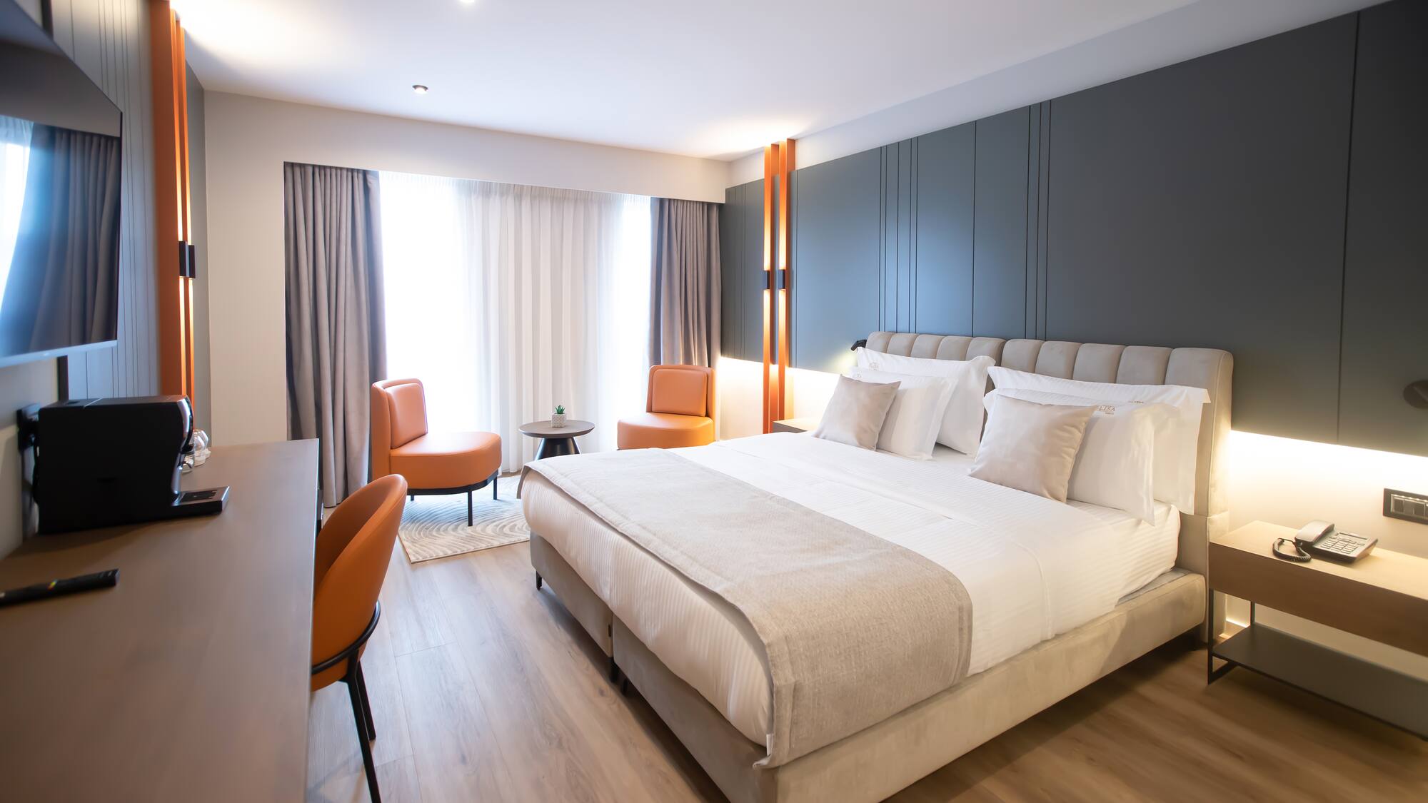 a room with a bed and chairs