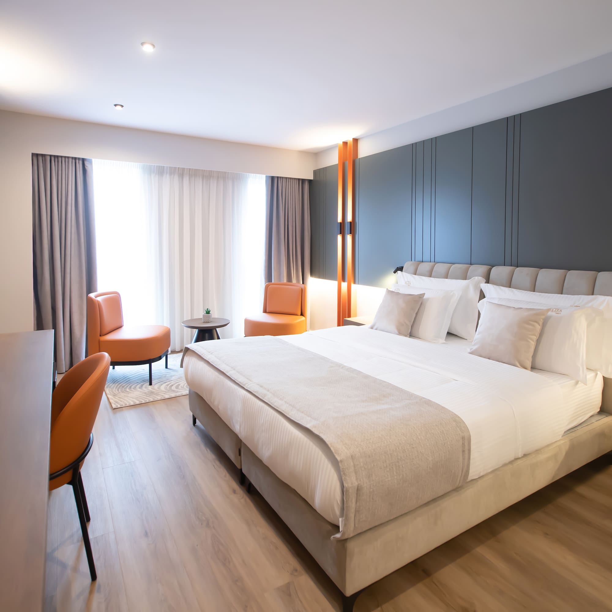 a room with a bed and chairs