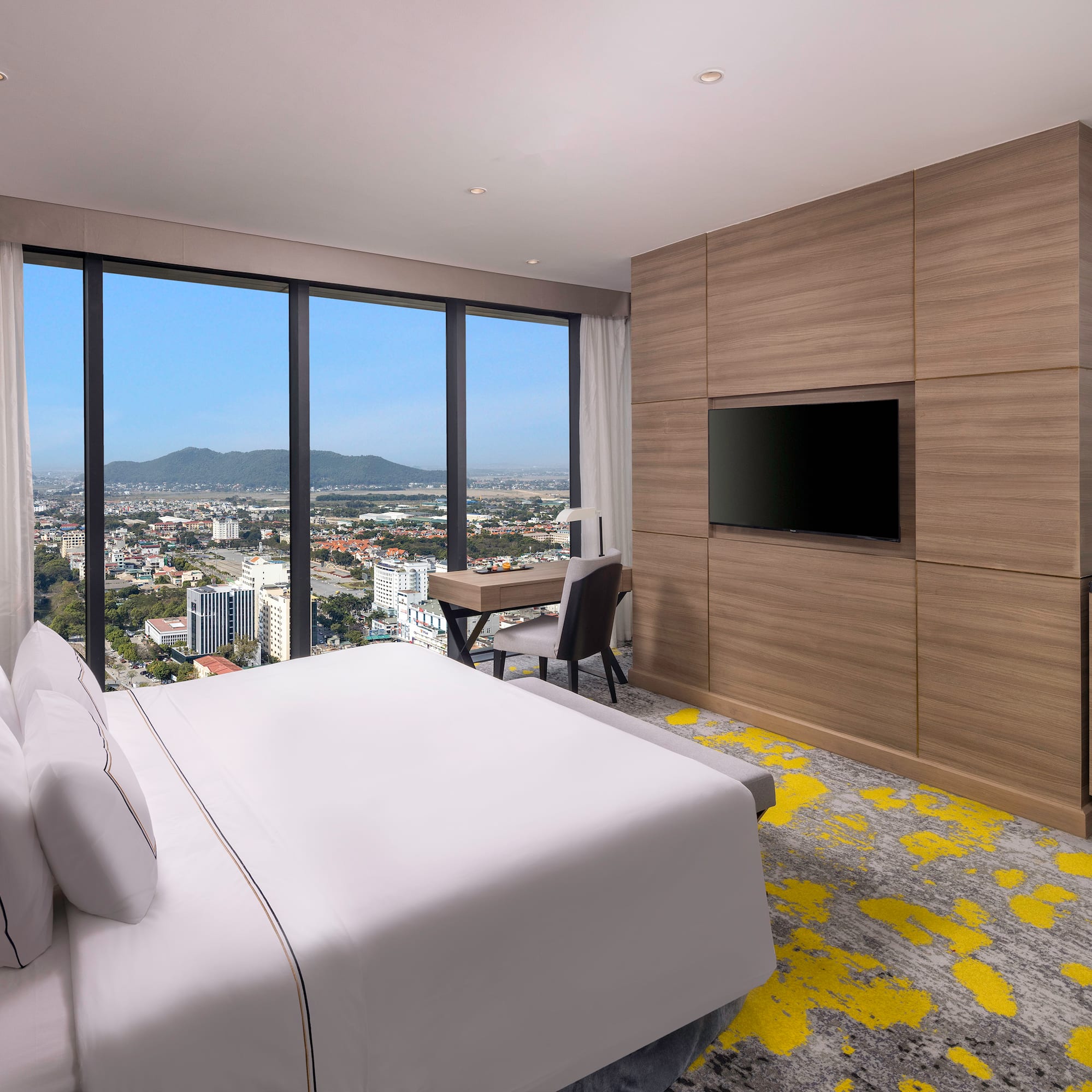 a room with a bed and a television