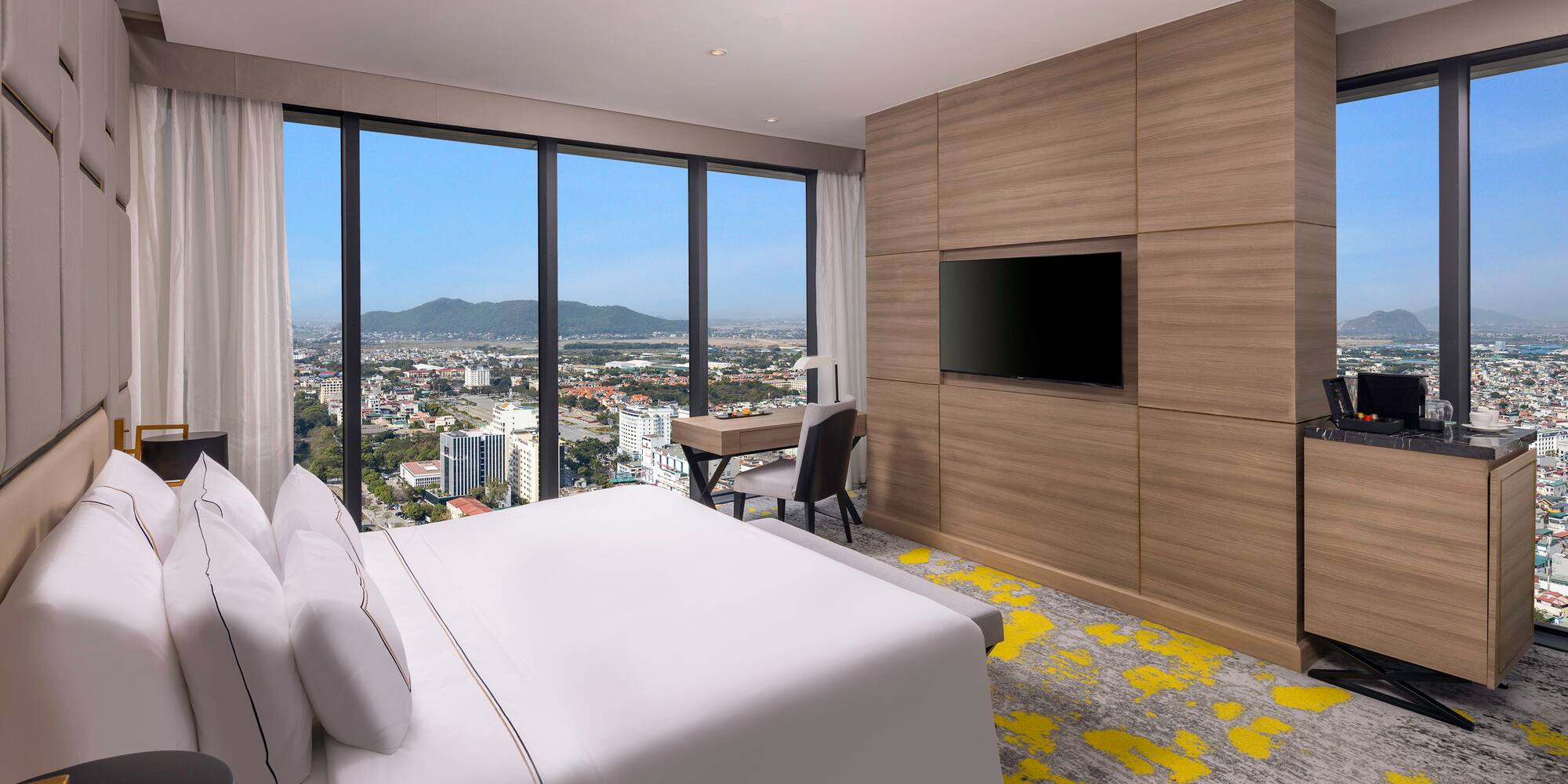 a room with a bed and a television