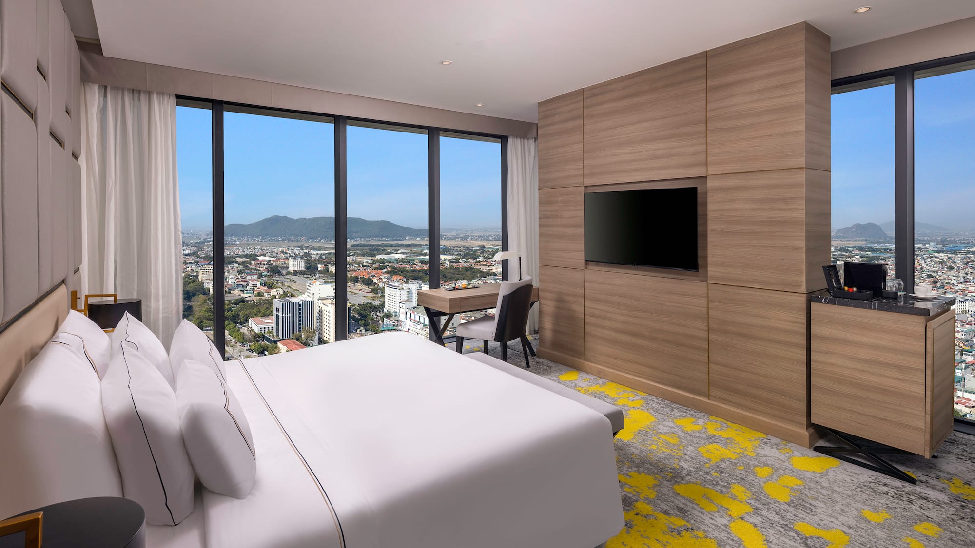 a room with a bed and a television