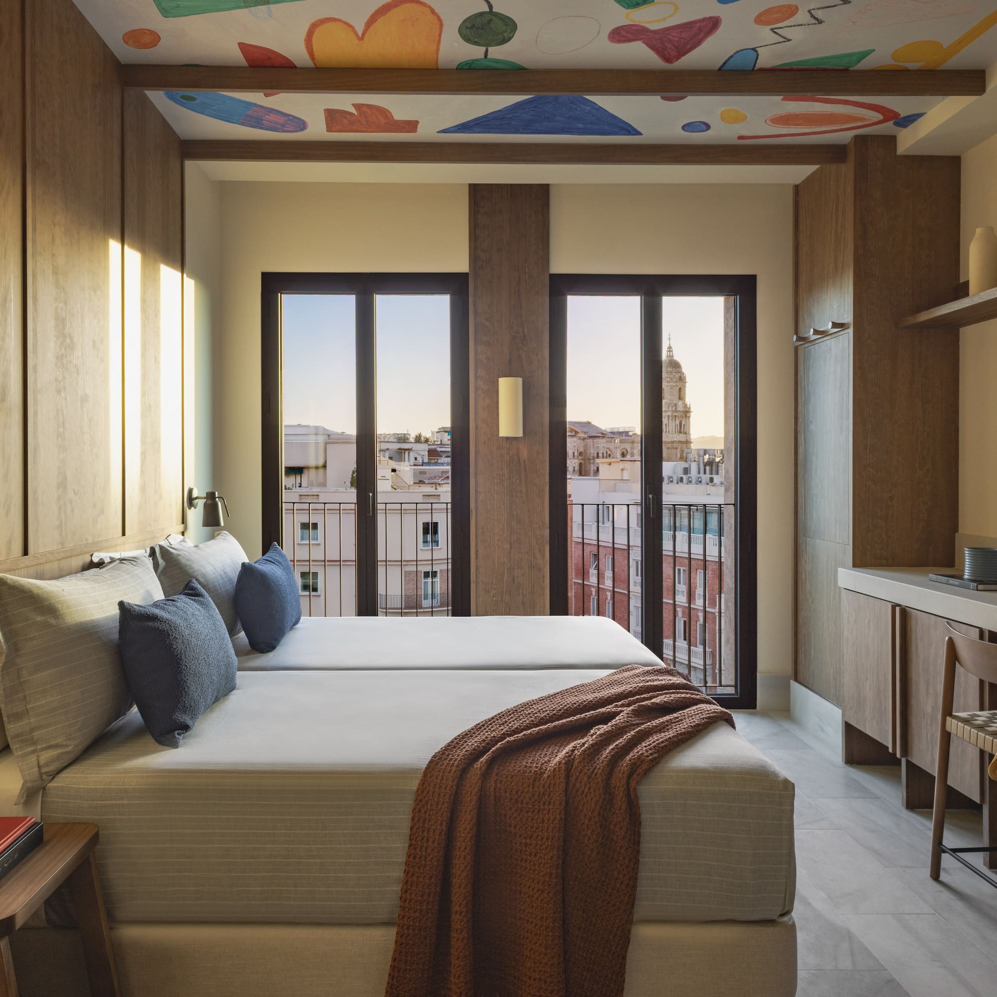 a room with a bed and a desk and a table