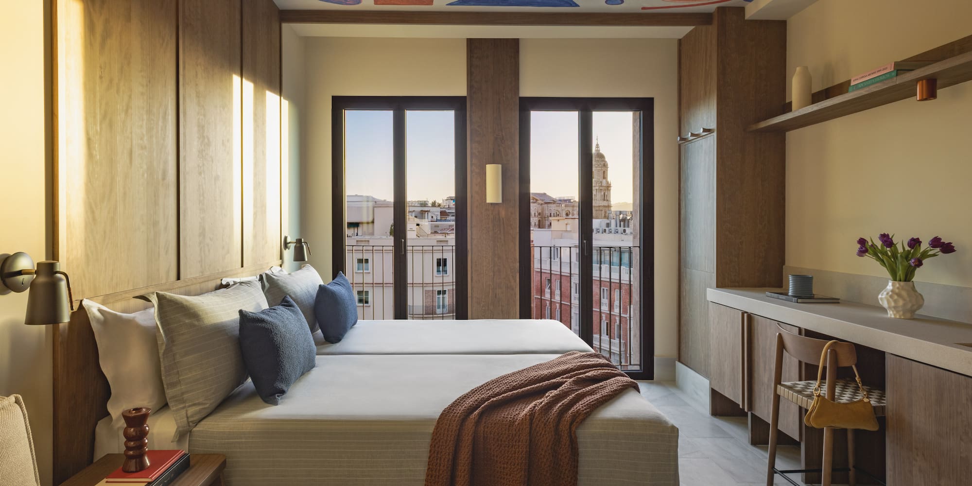 a room with a bed and a desk and a table