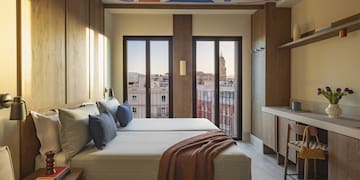 a room with a bed and a desk and a table