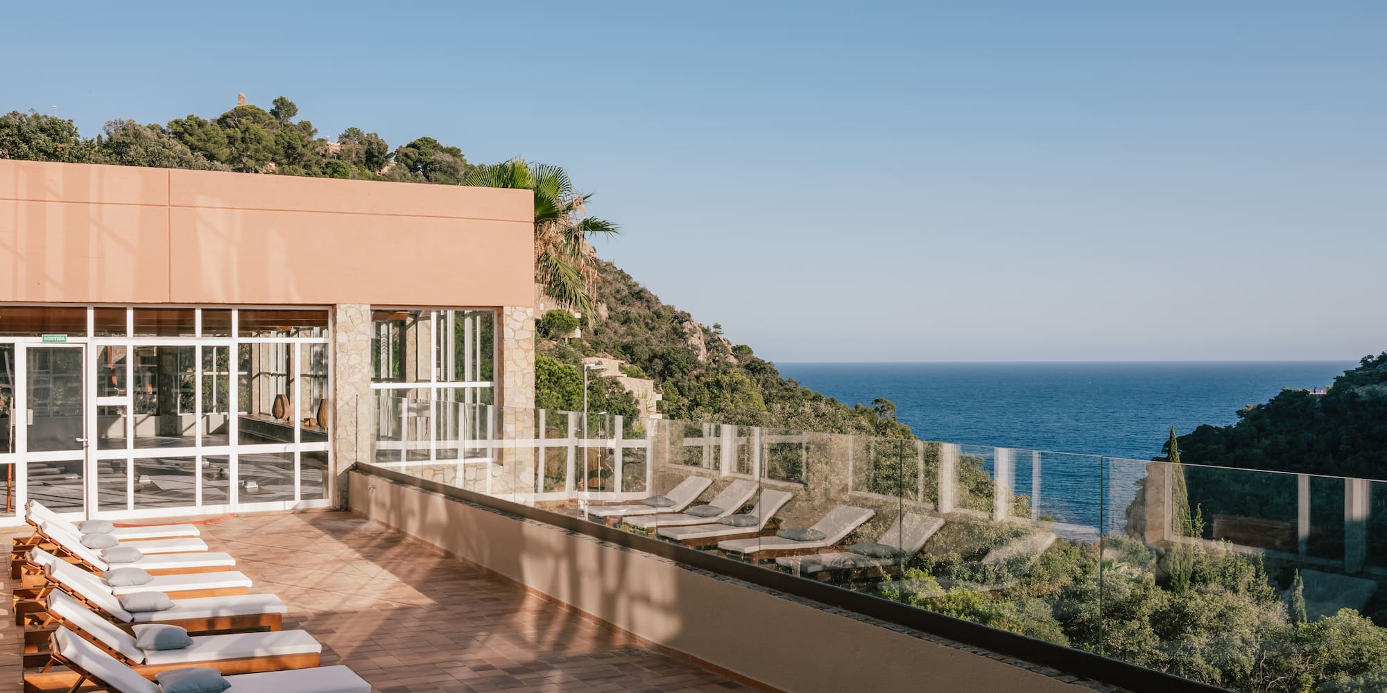 a deck with chairs and a body of water