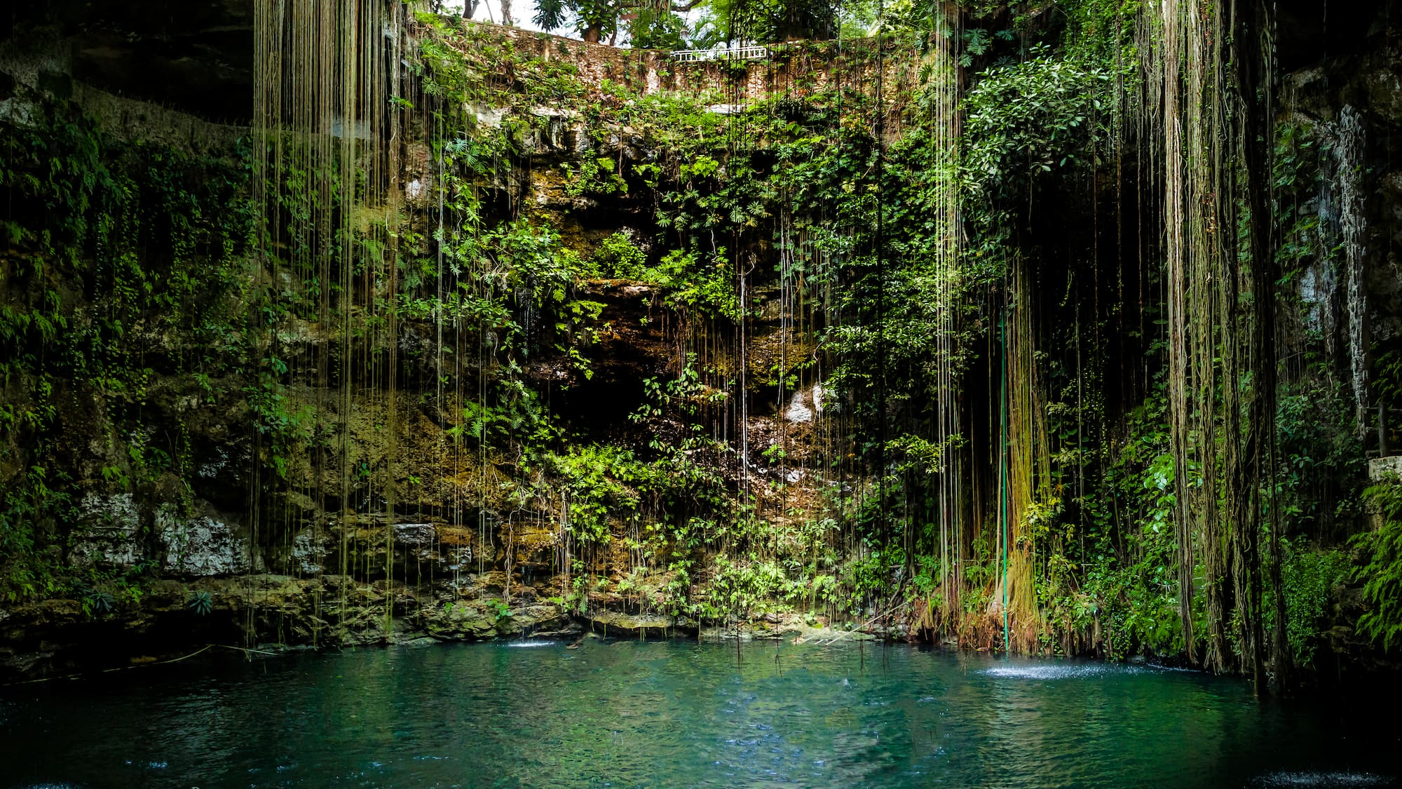 a water in a cave with Ik Kil in the background
