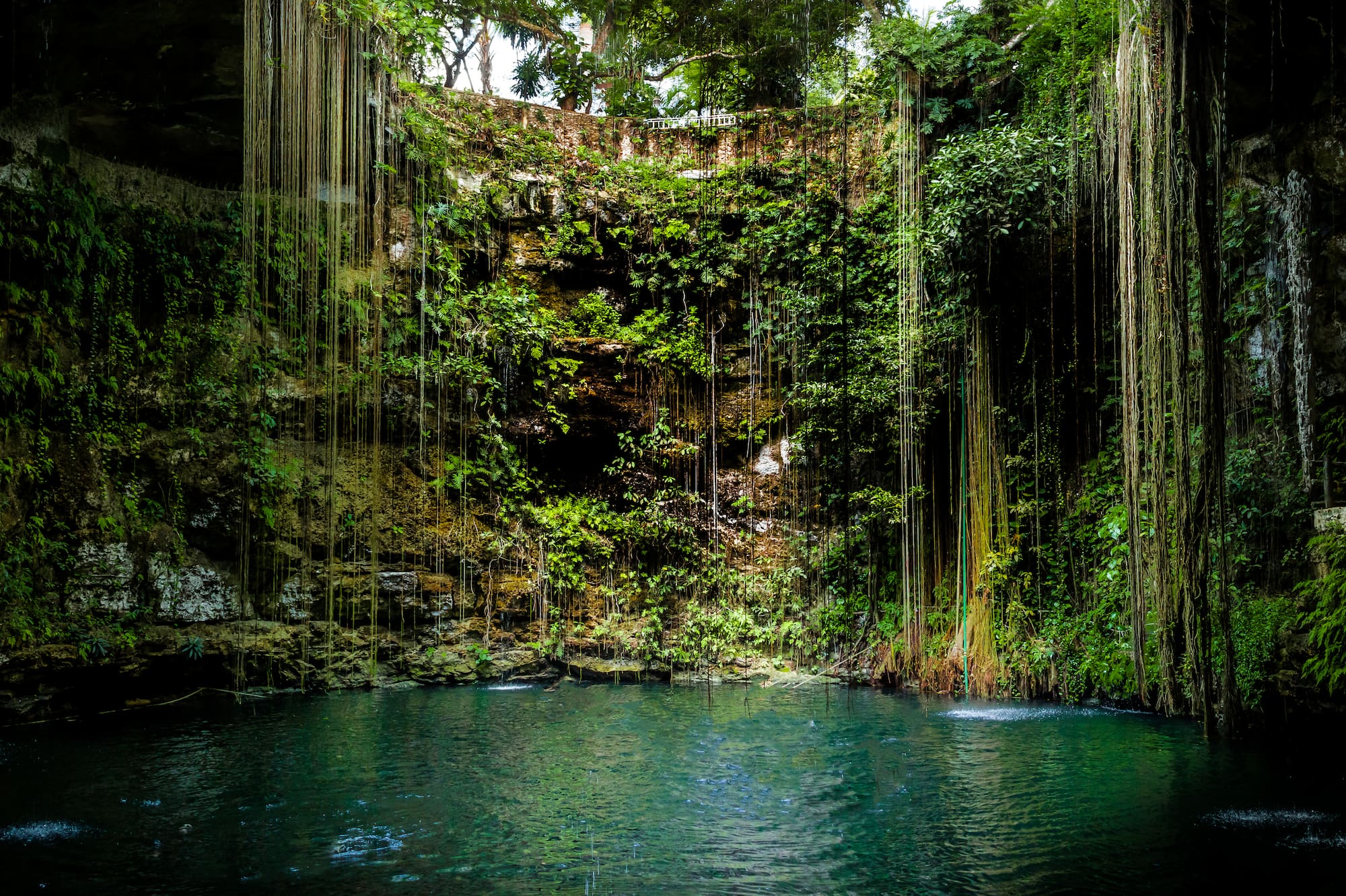 a water in a cave with Ik Kil in the background
