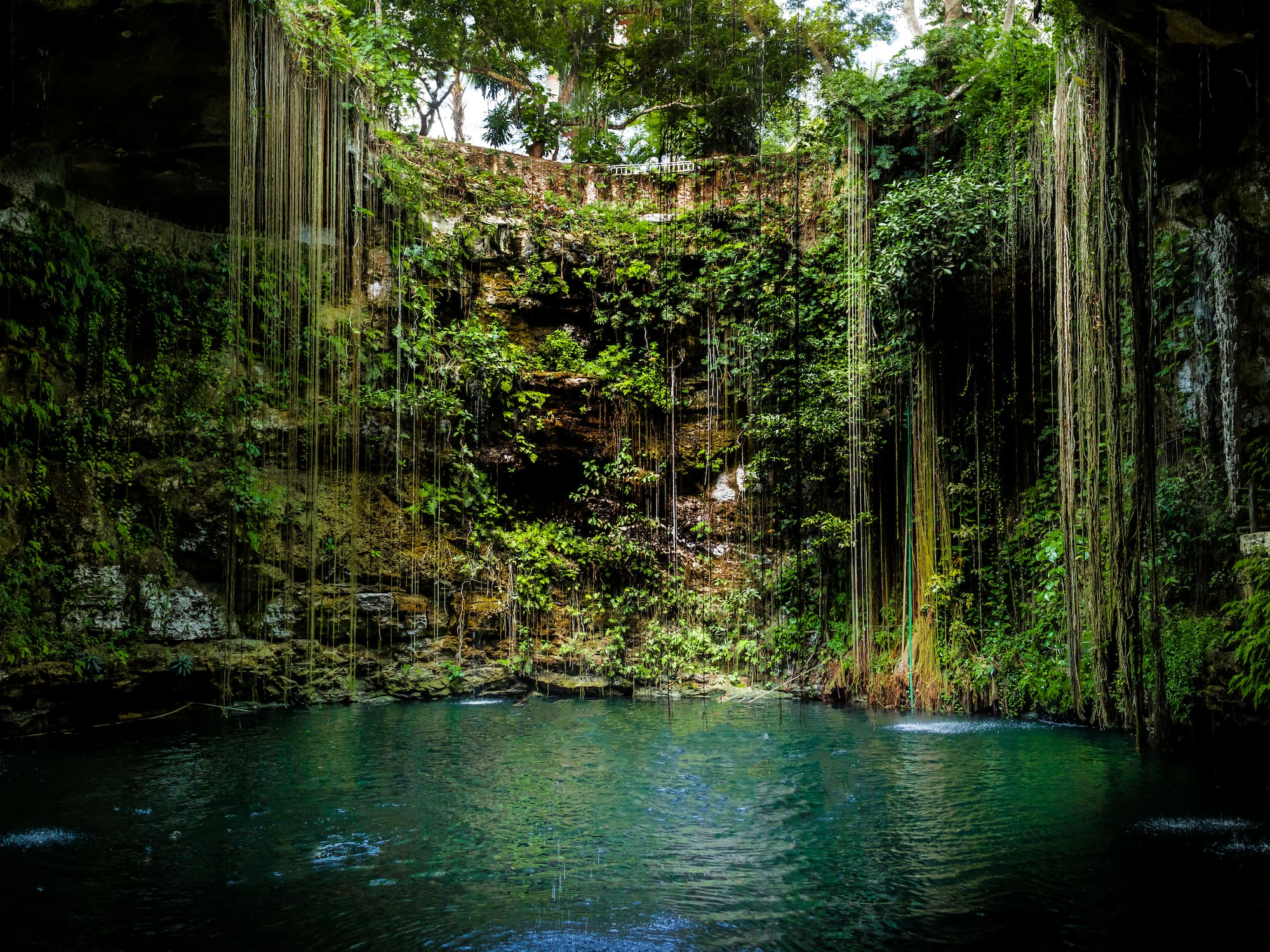 a water in a cave with Ik Kil in the background