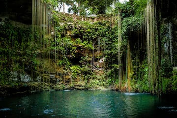a water in a cave with Ik Kil in the background
