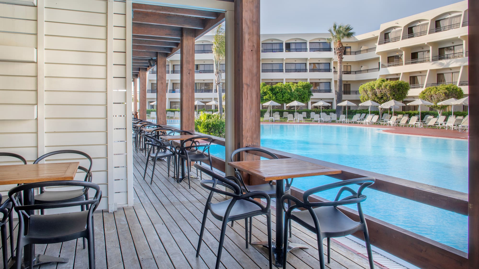 a pool with chairs and tables