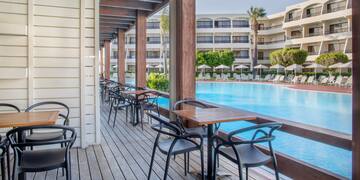 a pool with chairs and tables