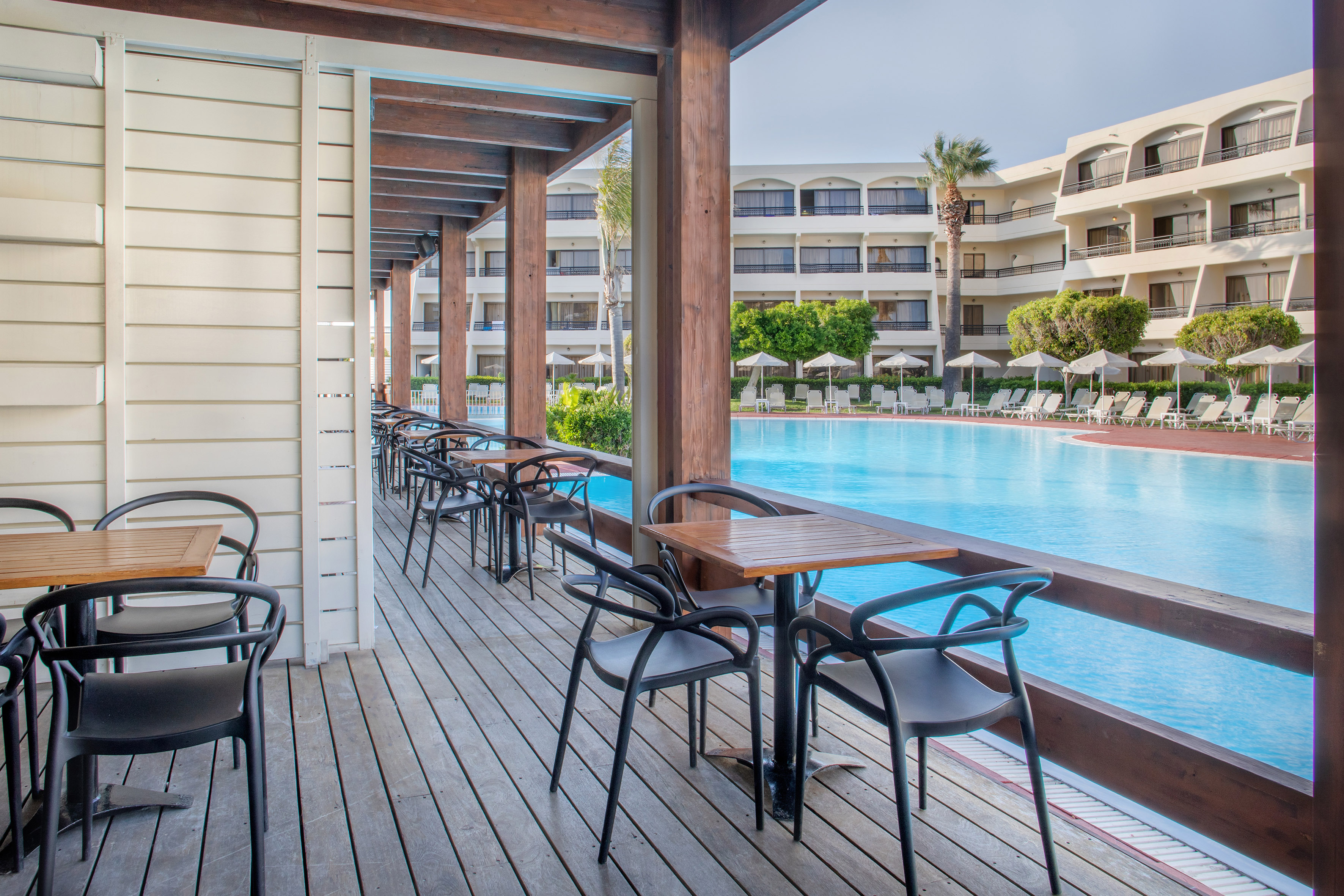 a pool with chairs and tables
