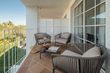 a patio with chairs and a table