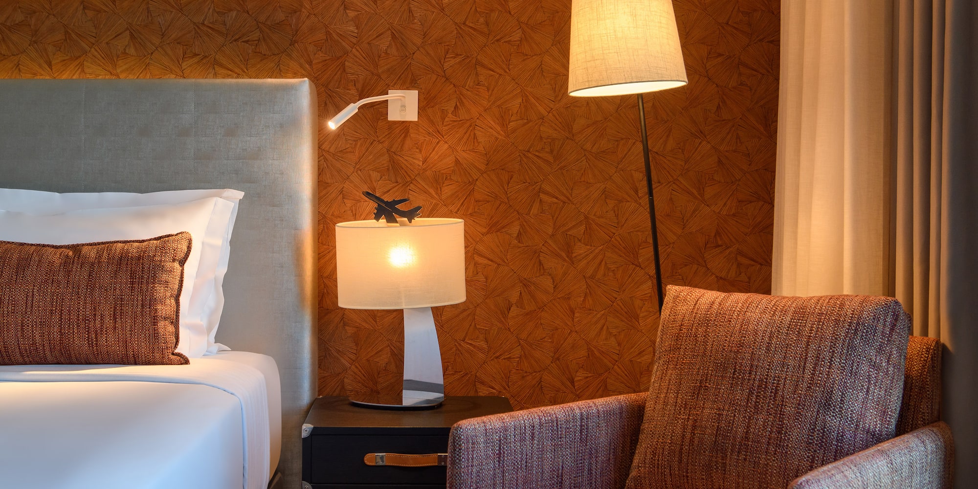 a lamp next to a bed