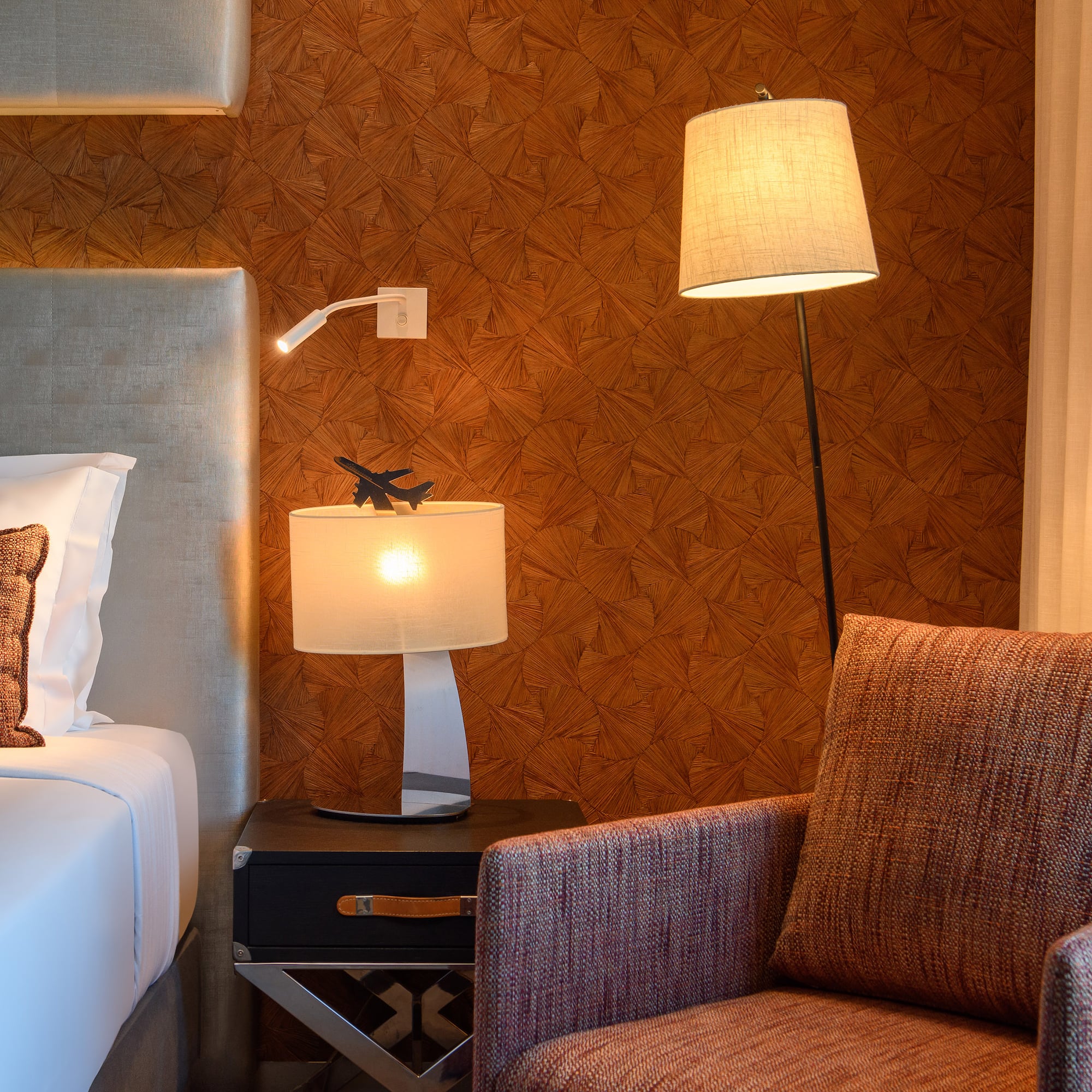 a lamp next to a bed