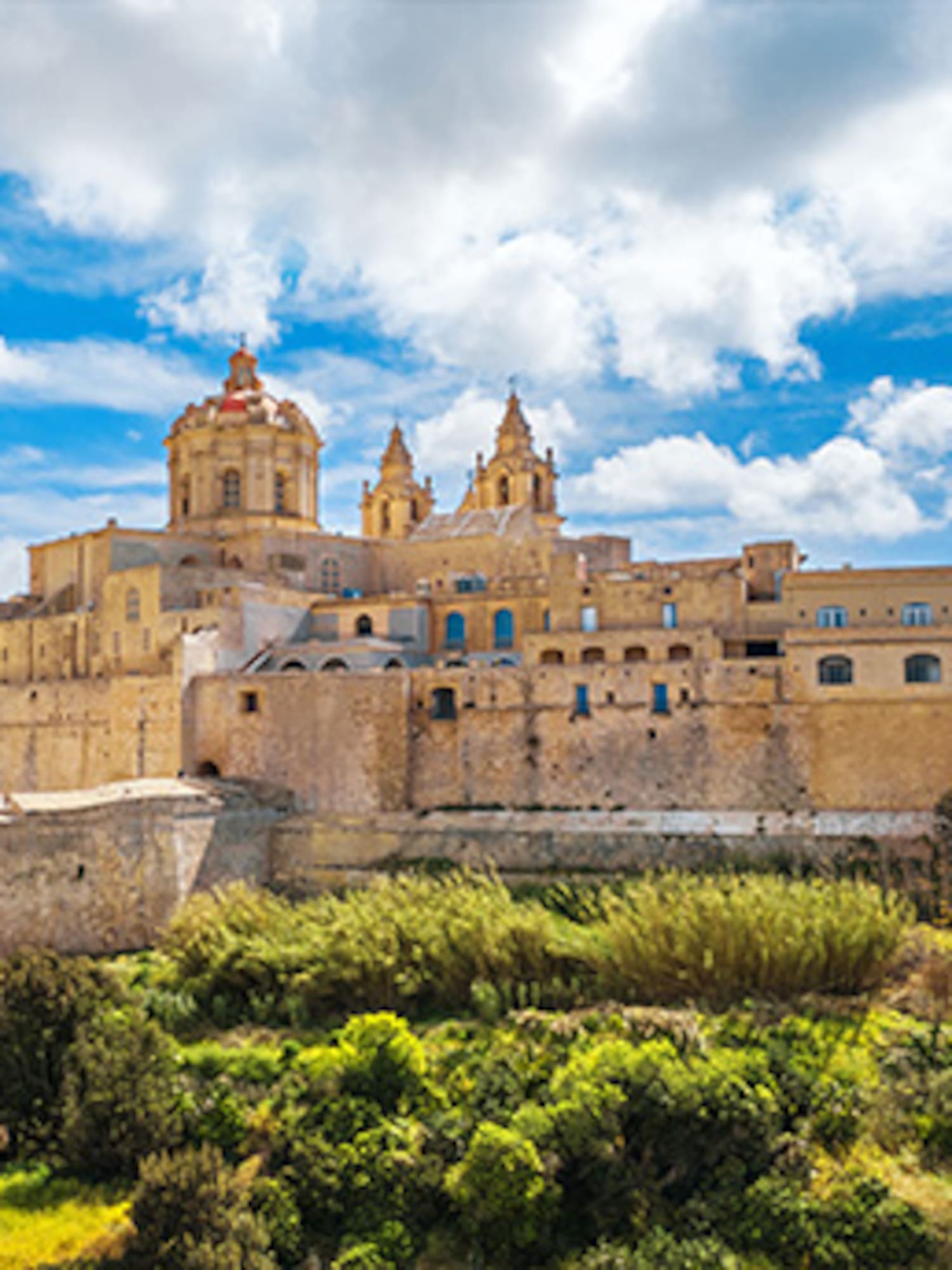 Mdina, Malta: historic fortified city with cathedral domes against blue sky.