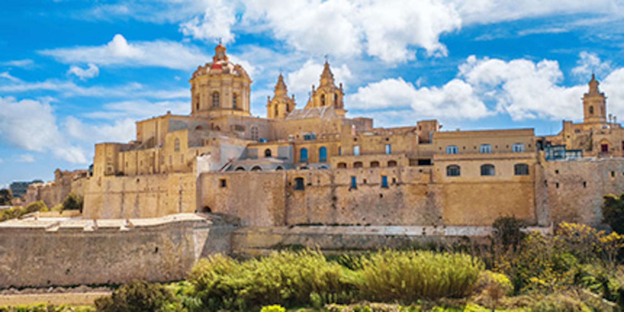 Mdina, Malta: historic fortified city with cathedral domes against blue sky.