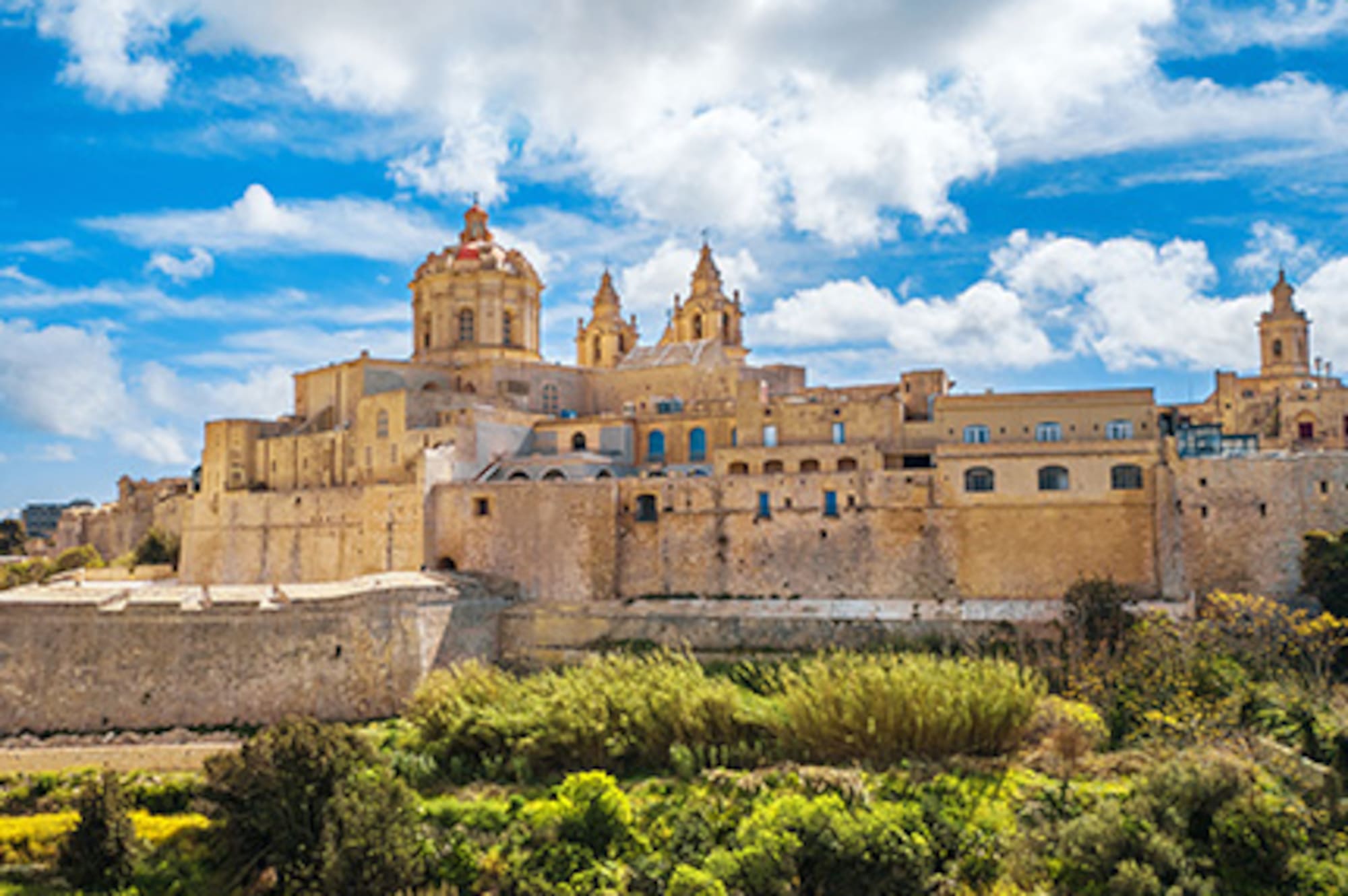 Mdina, Malta: historic fortified city with cathedral domes against blue sky.