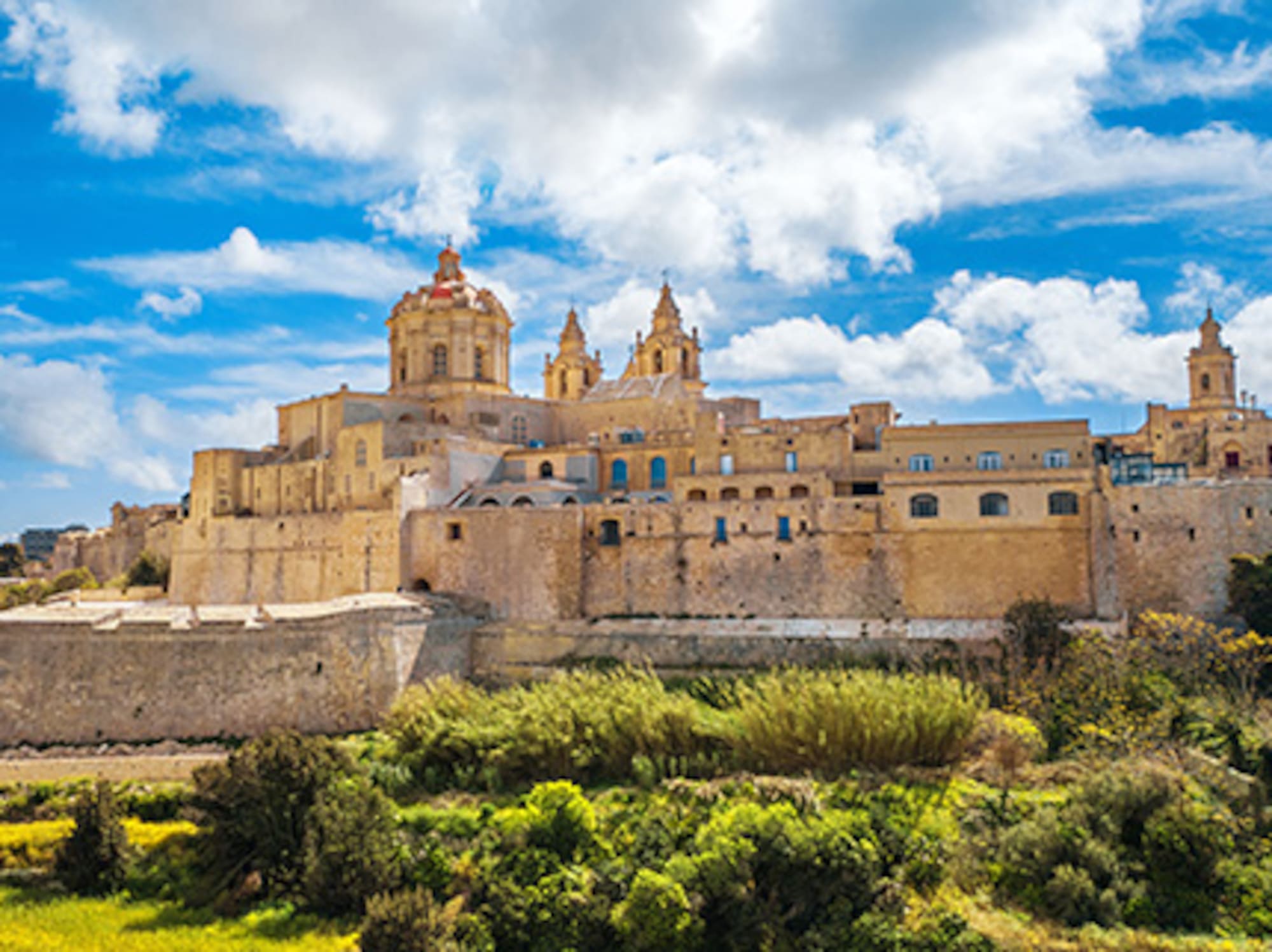 Mdina, Malta: historic fortified city with cathedral domes against blue sky.