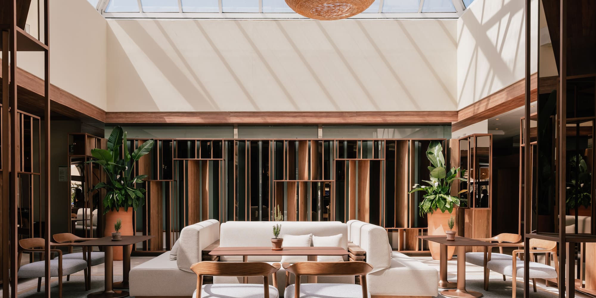 a room with a glass roof and a table and chairs