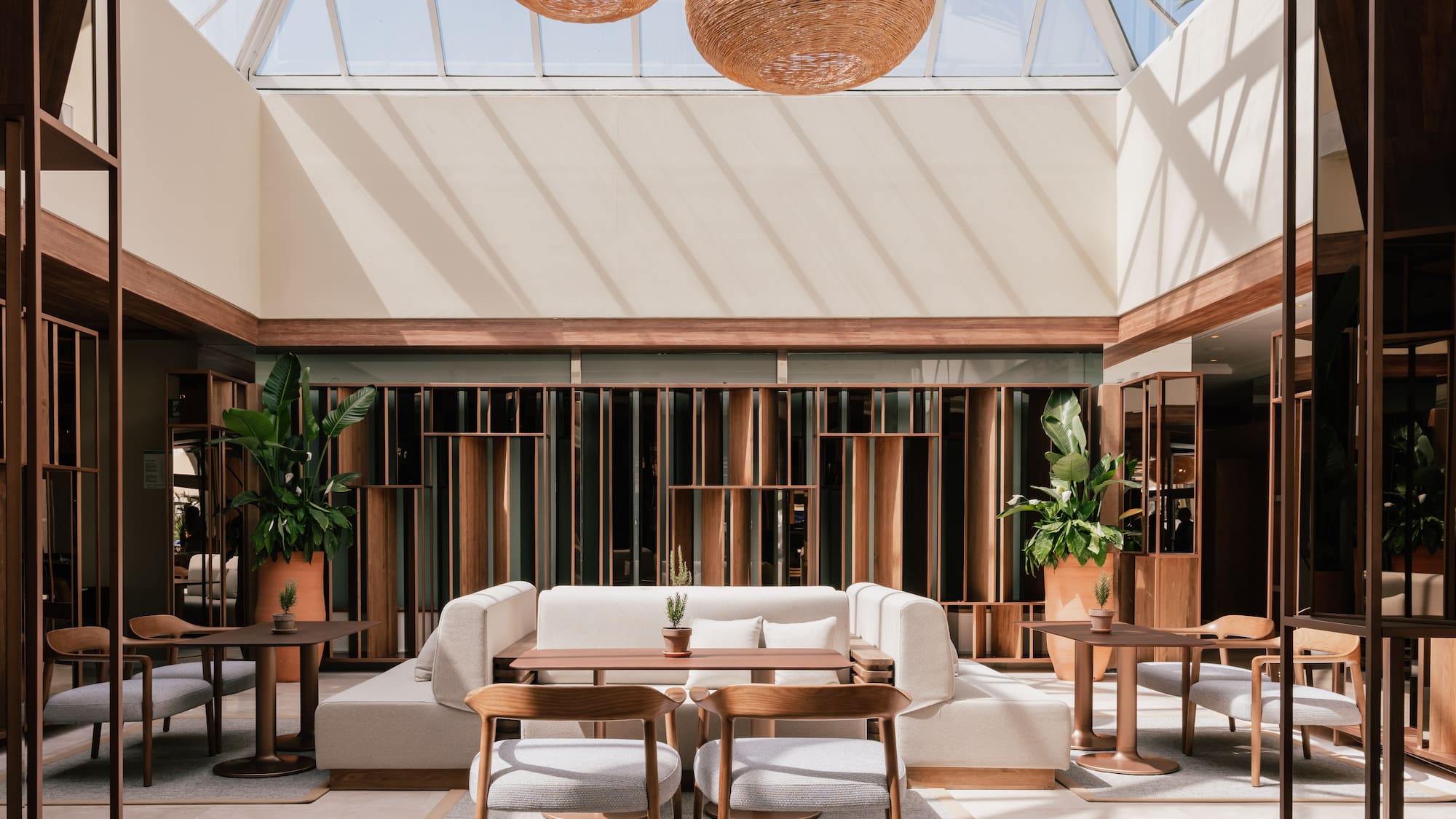 a room with a glass roof and a table and chairs