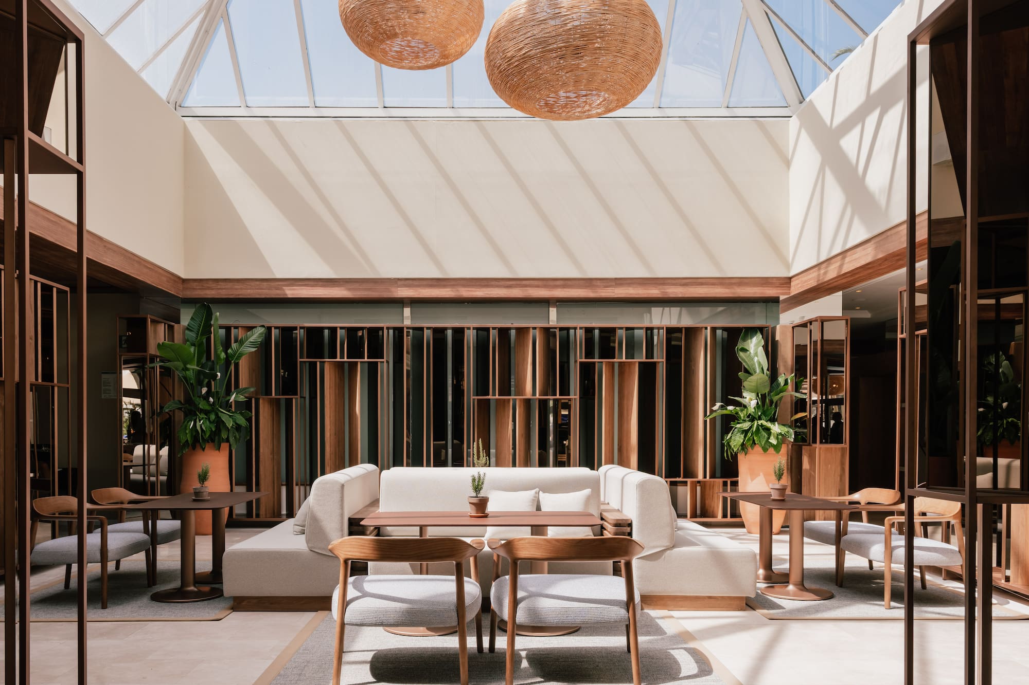 a room with a glass roof and a table and chairs