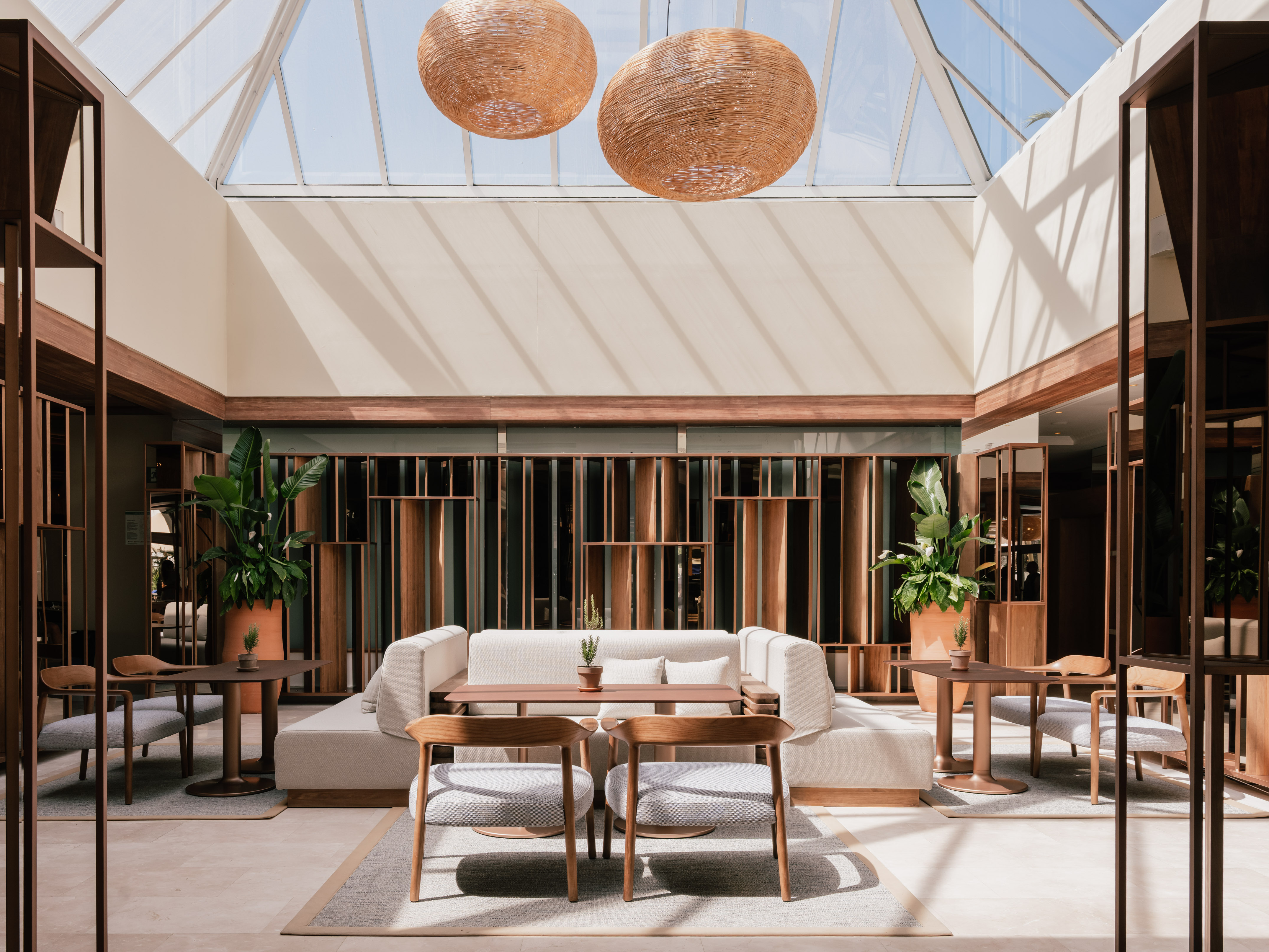 a room with a glass roof and a table and chairs