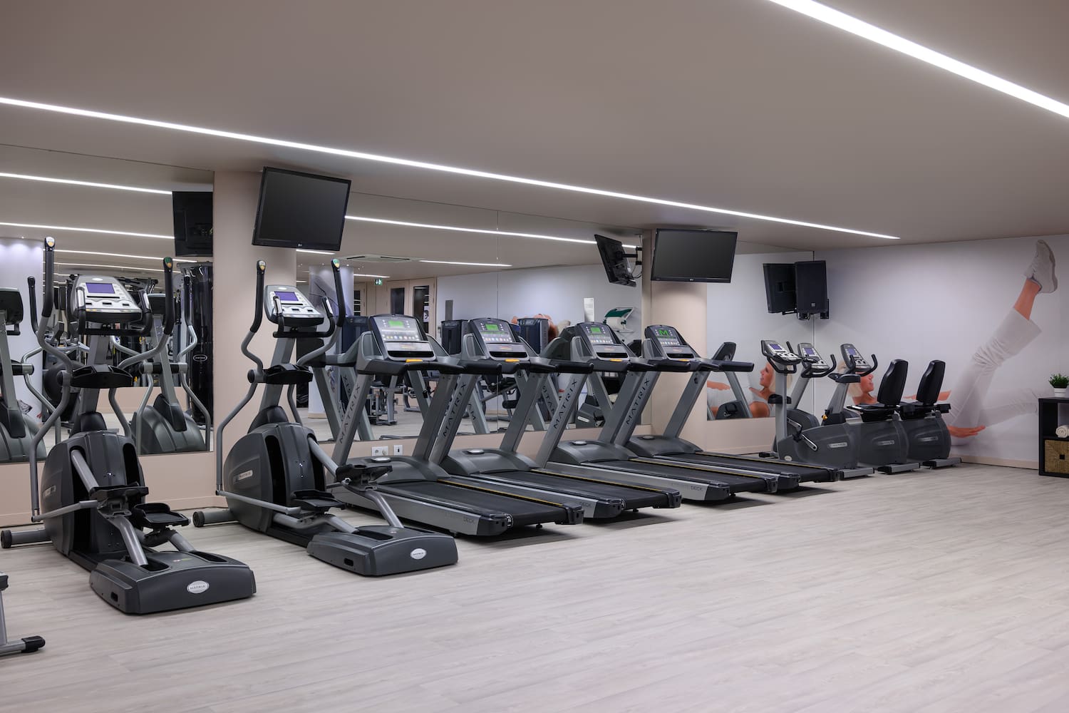 a gym with treadmills and a mirror