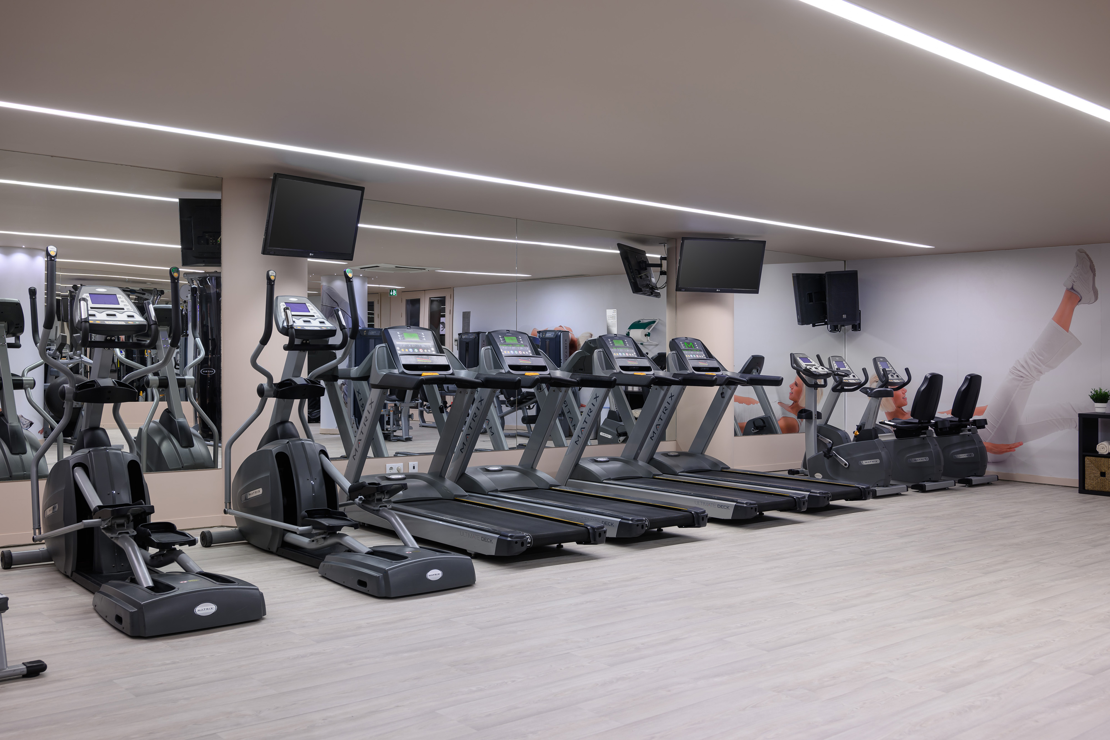 a gym with treadmills and a mirror