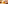 Hand picking a jamón croquette from a rustic wooden board with blurred tapas.