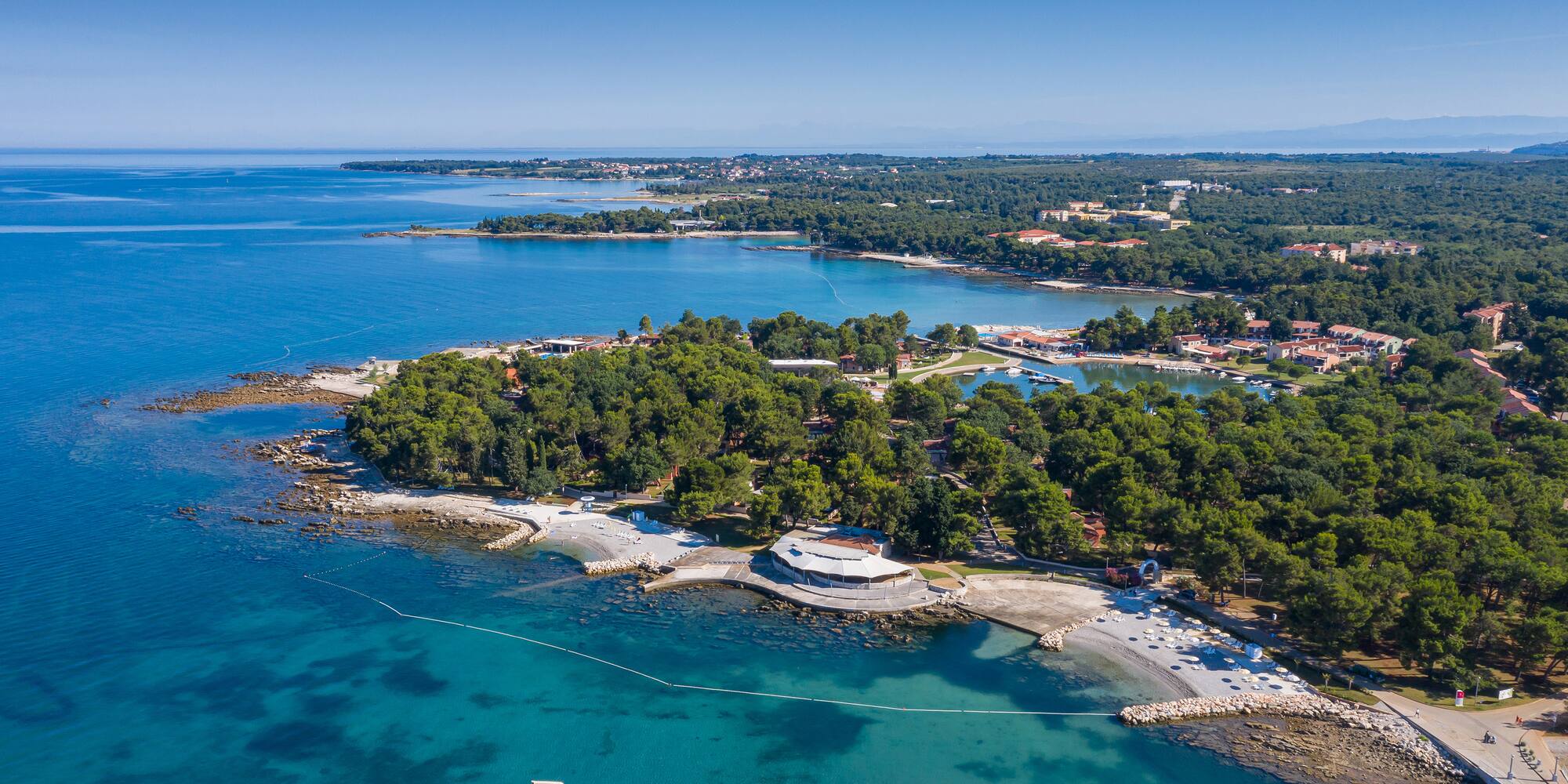 an aerial view of a small island with trees and water