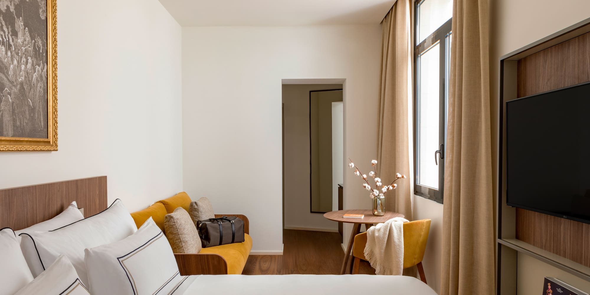 a room with a bed and a table and chairs