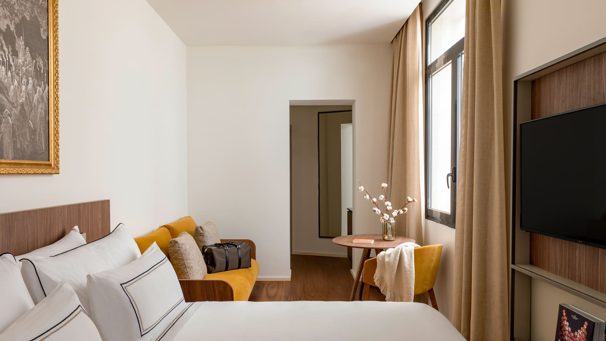 a room with a bed and a table and chairs