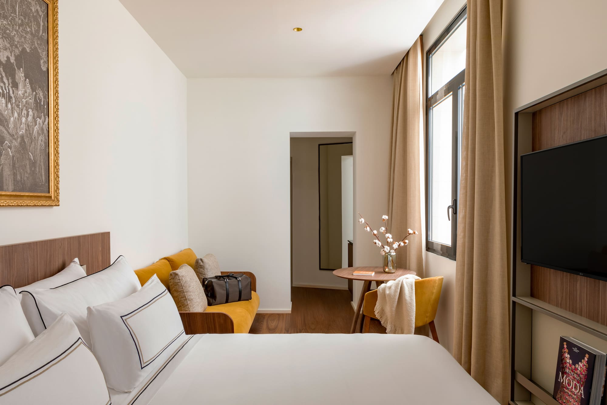 a room with a bed and a table and chairs