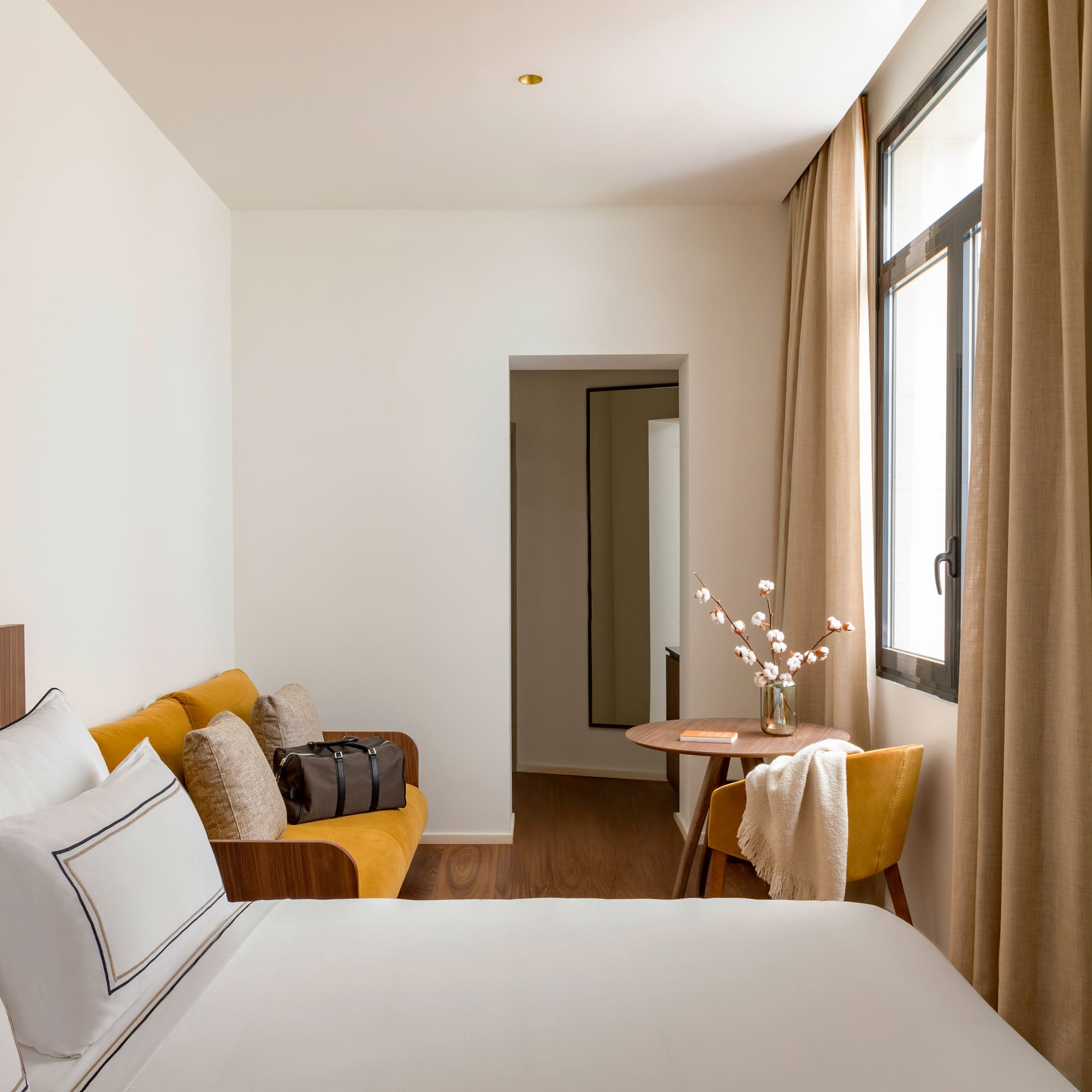 a room with a bed and a table and chairs