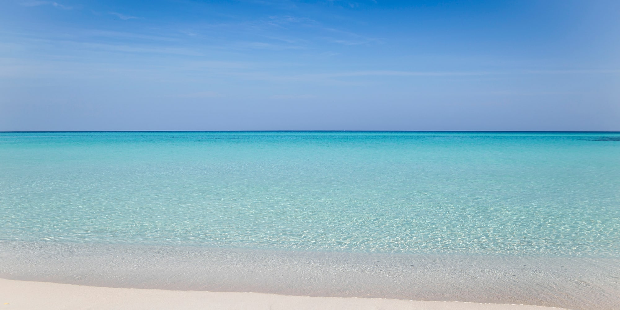 a beach with clear blue water