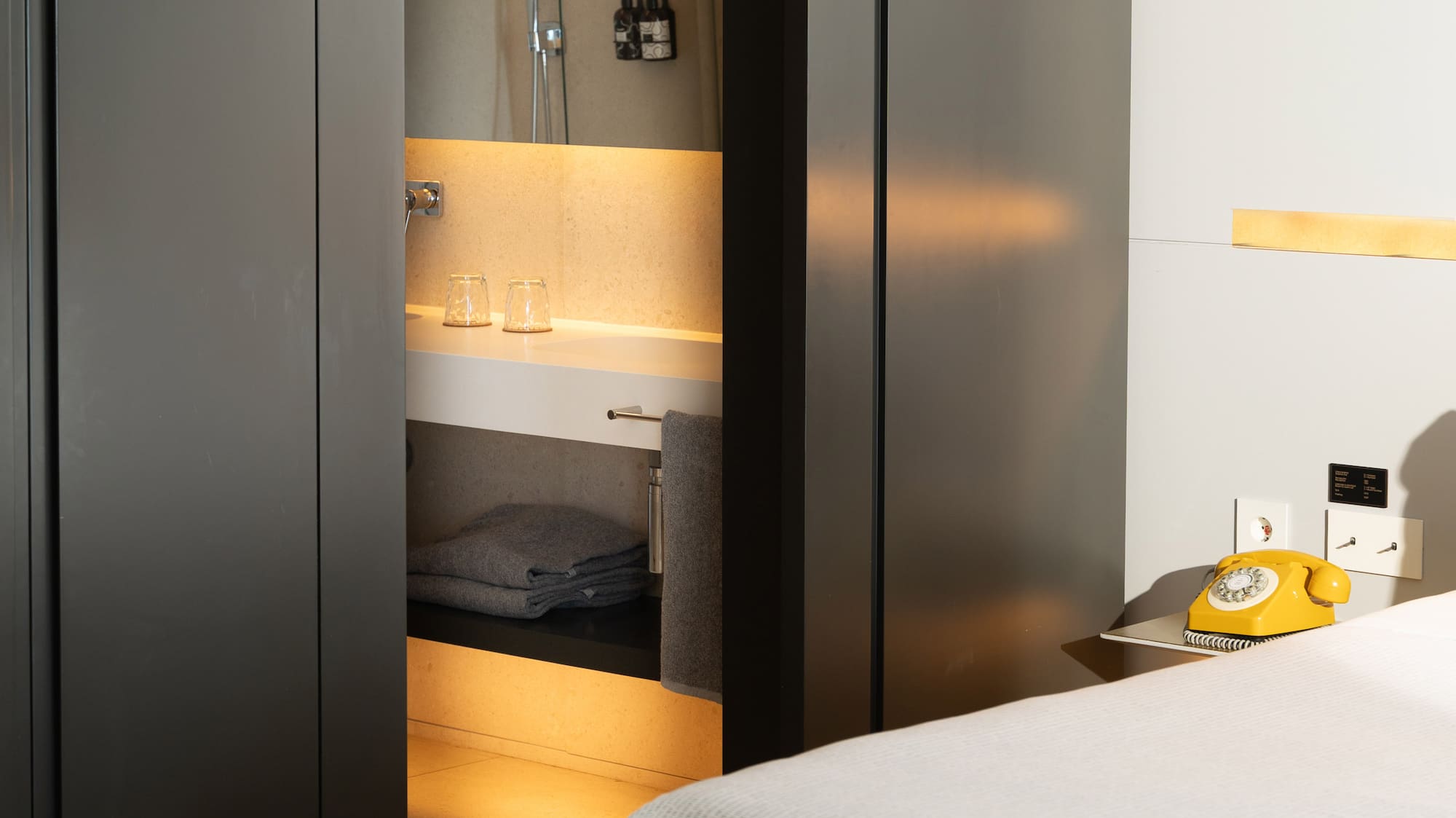 a room with a bed and a sink