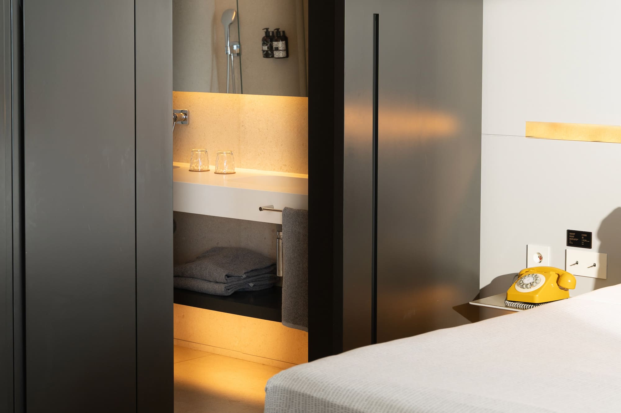 a room with a bed and a sink