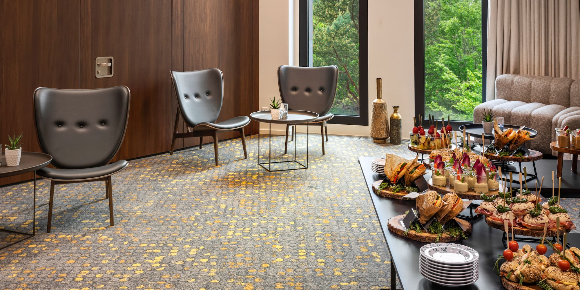 a table with food on it in a room with chairs and a door