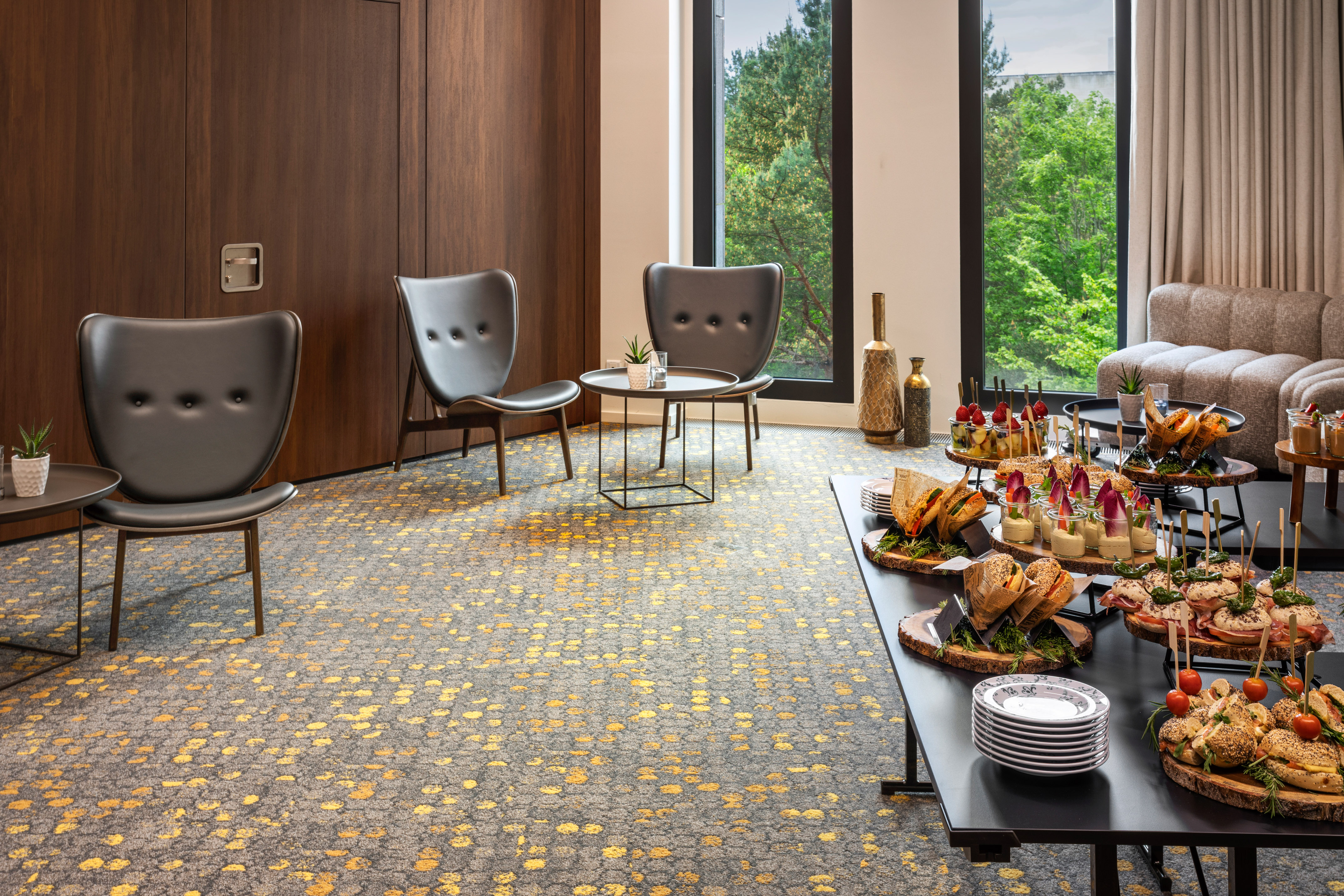 a table with food on it in a room with chairs and a door