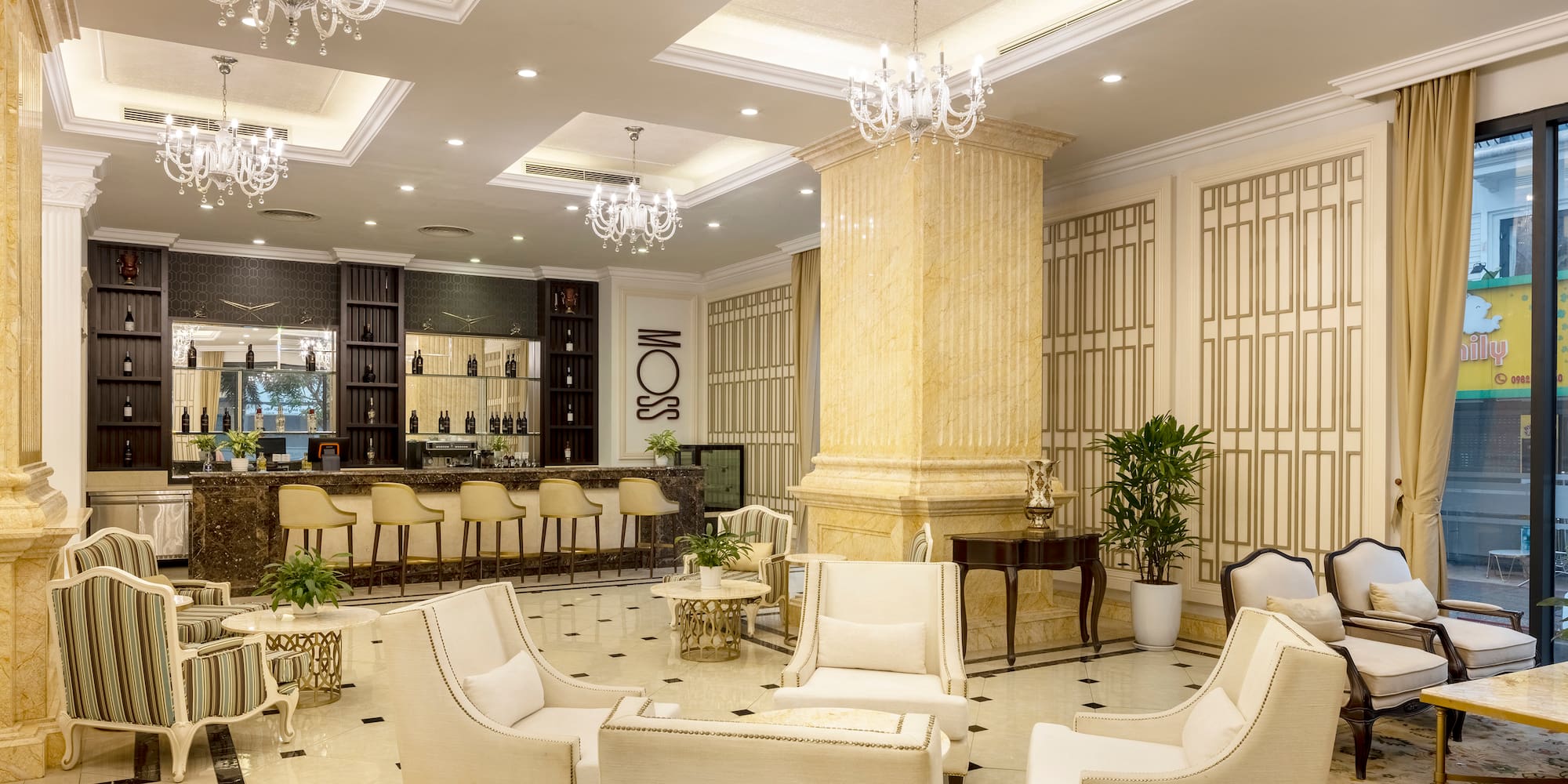 a room with white chairs and a bar