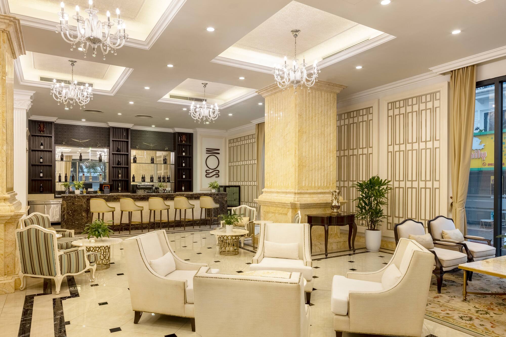 a room with white chairs and a bar